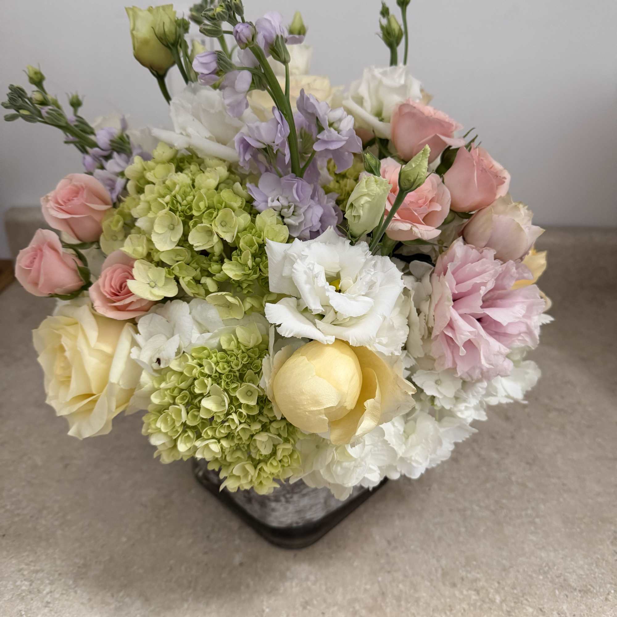pastel colors, with pink Lisianthus , and pink spray roses, lavender stock