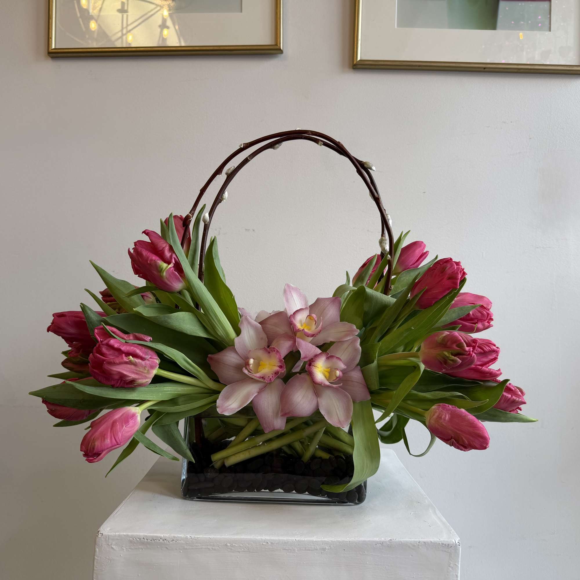 Marvel Parrot tulips
cymbidium orchid pink,
black stones 
in short vase 