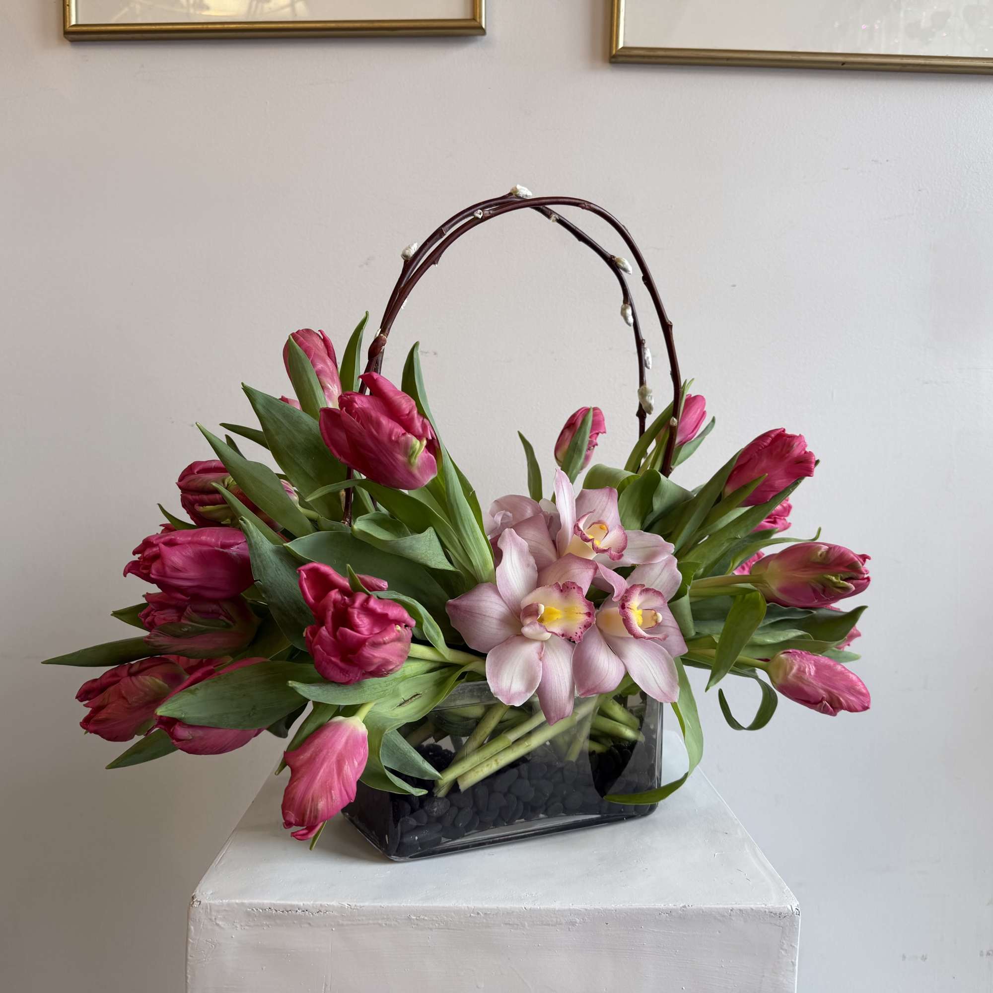 Marvel Parrot tulips
cymbidium orchid pink,
black stones 
in short vase 