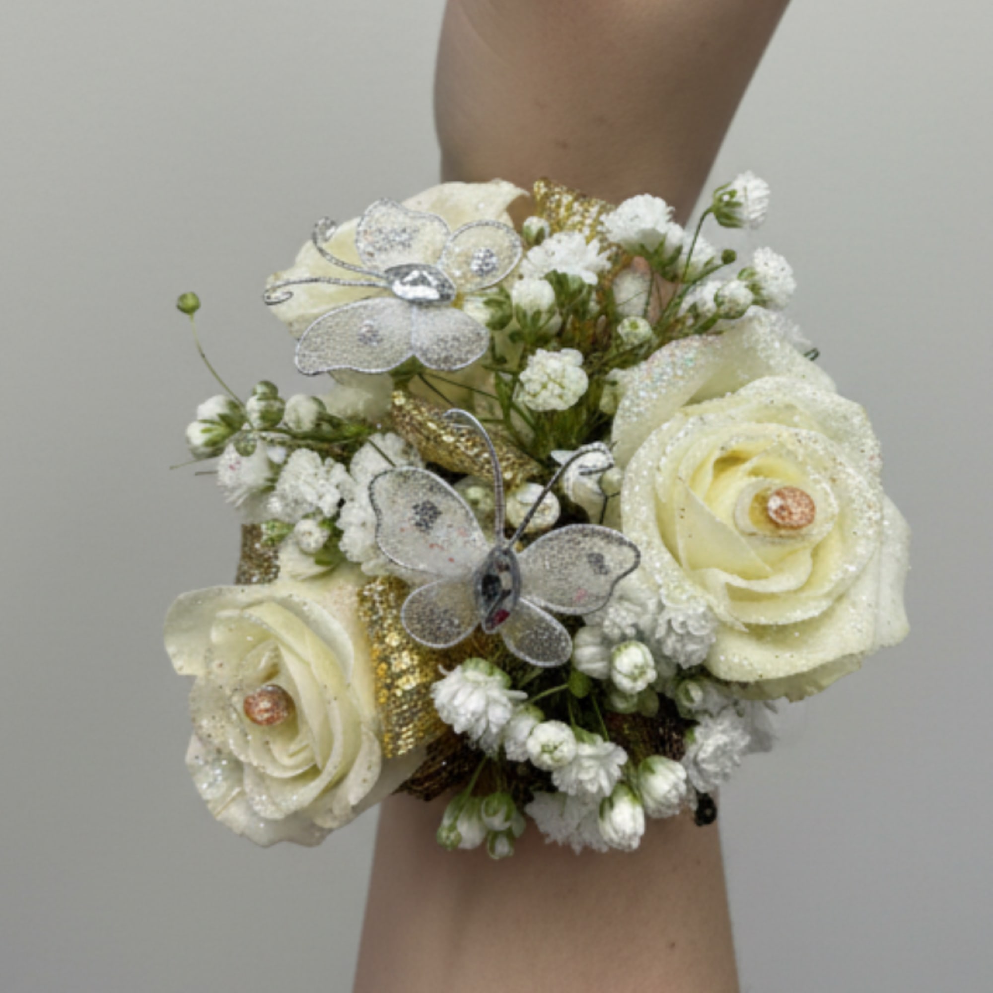 The perfect corsage for your "Golden Sweetheart" with three pink baby roses