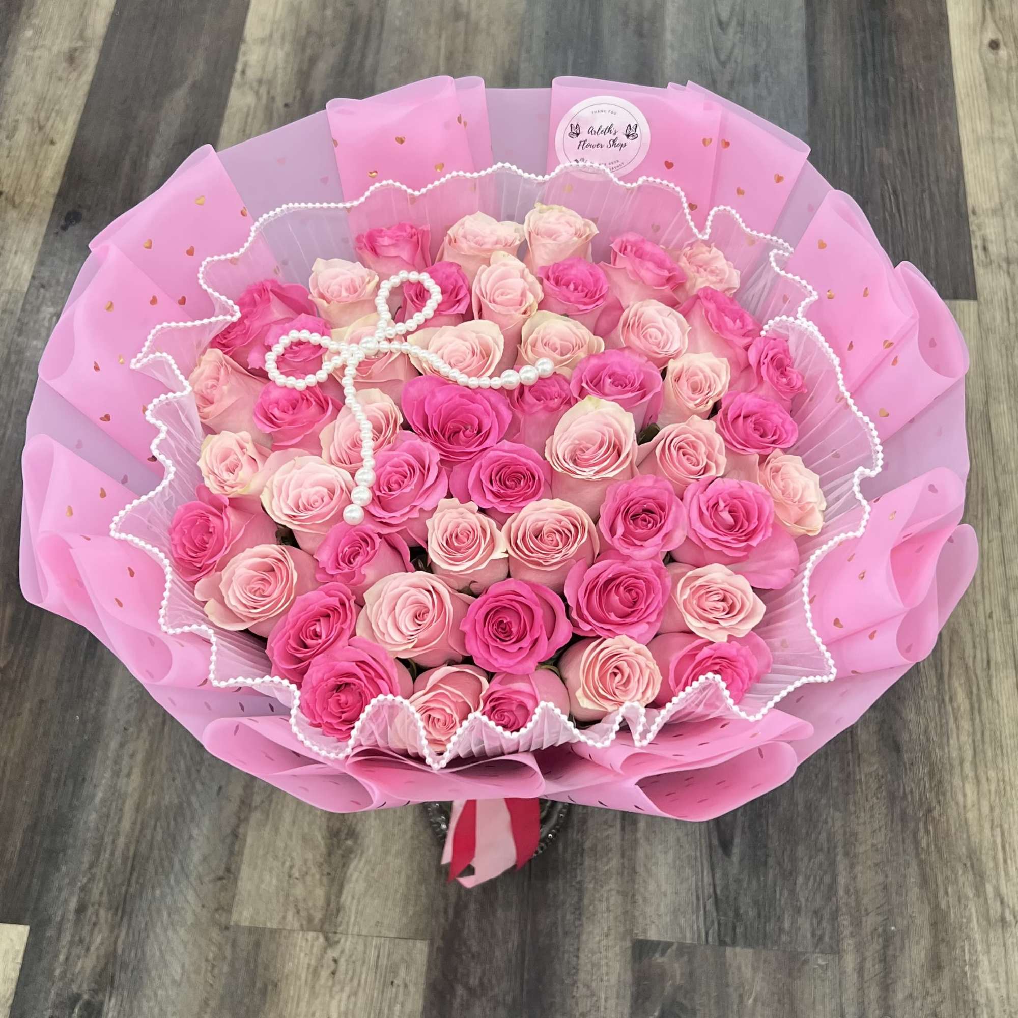 Bouquet of pink and blush roses wrapped in pink paper