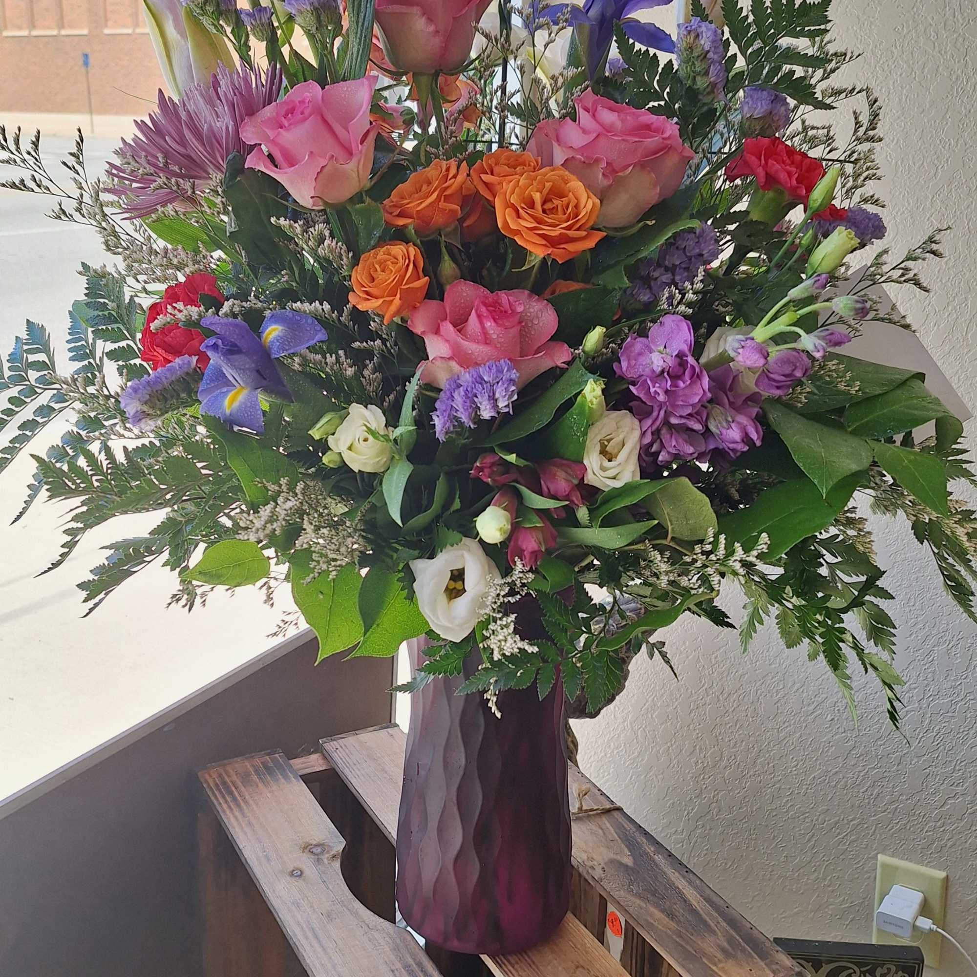  This rich mix of lilies, roses and lovely blossoms, simply arranged