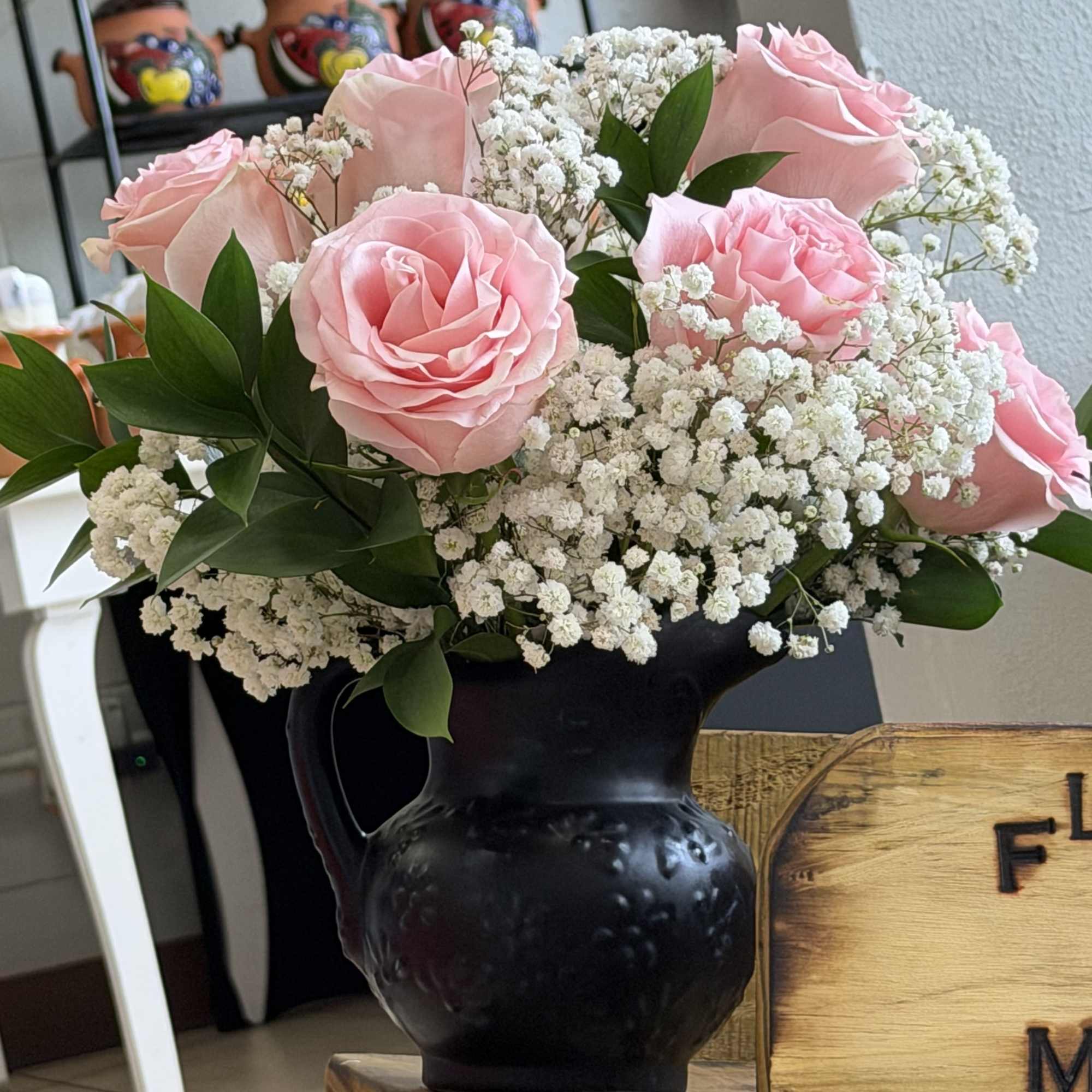 Soft pink roses gathered into a tight, rounded bouquet create a soft