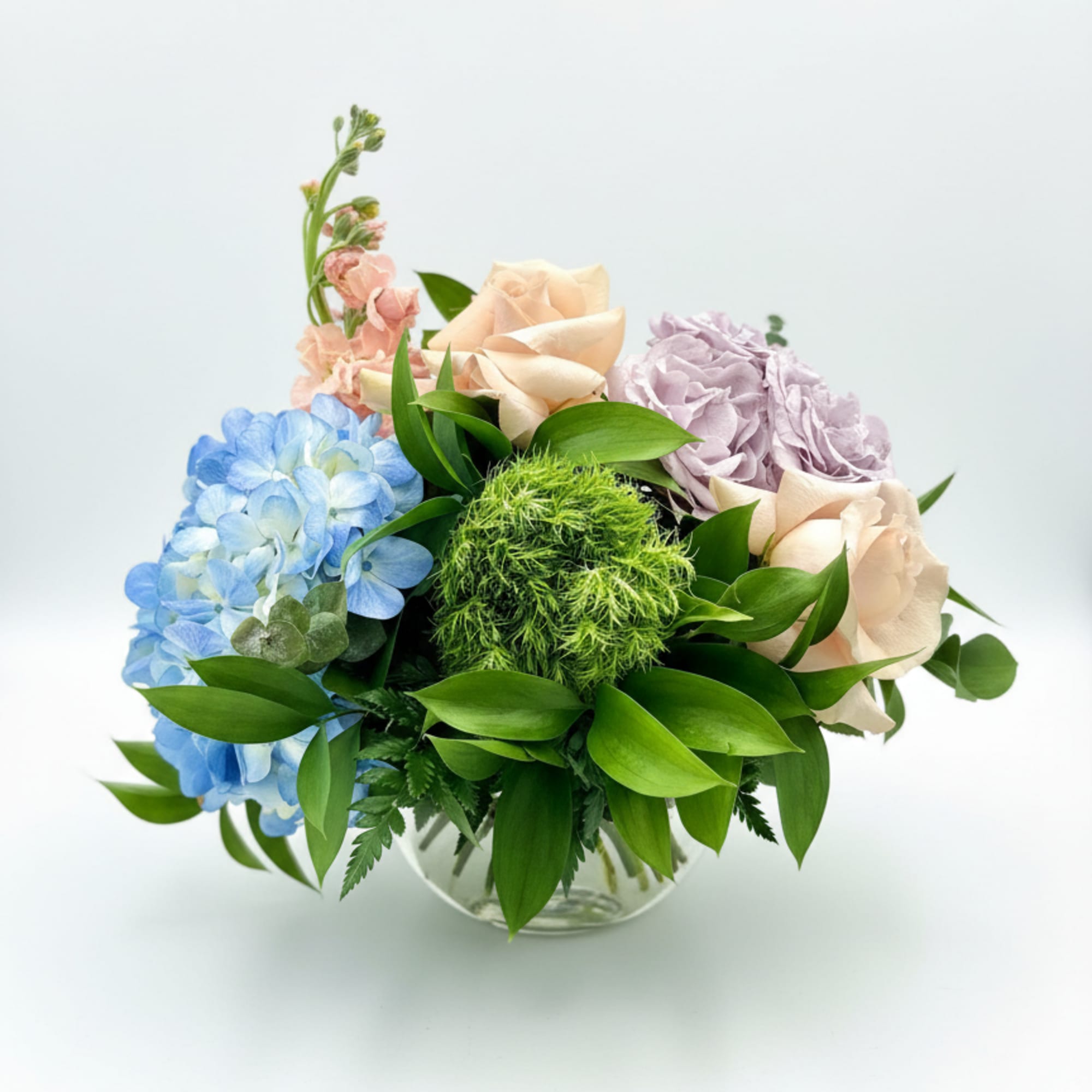 Quicksand roses, blue hydrangeas &amp; green dianthus in a summery low arrangement-vibrant