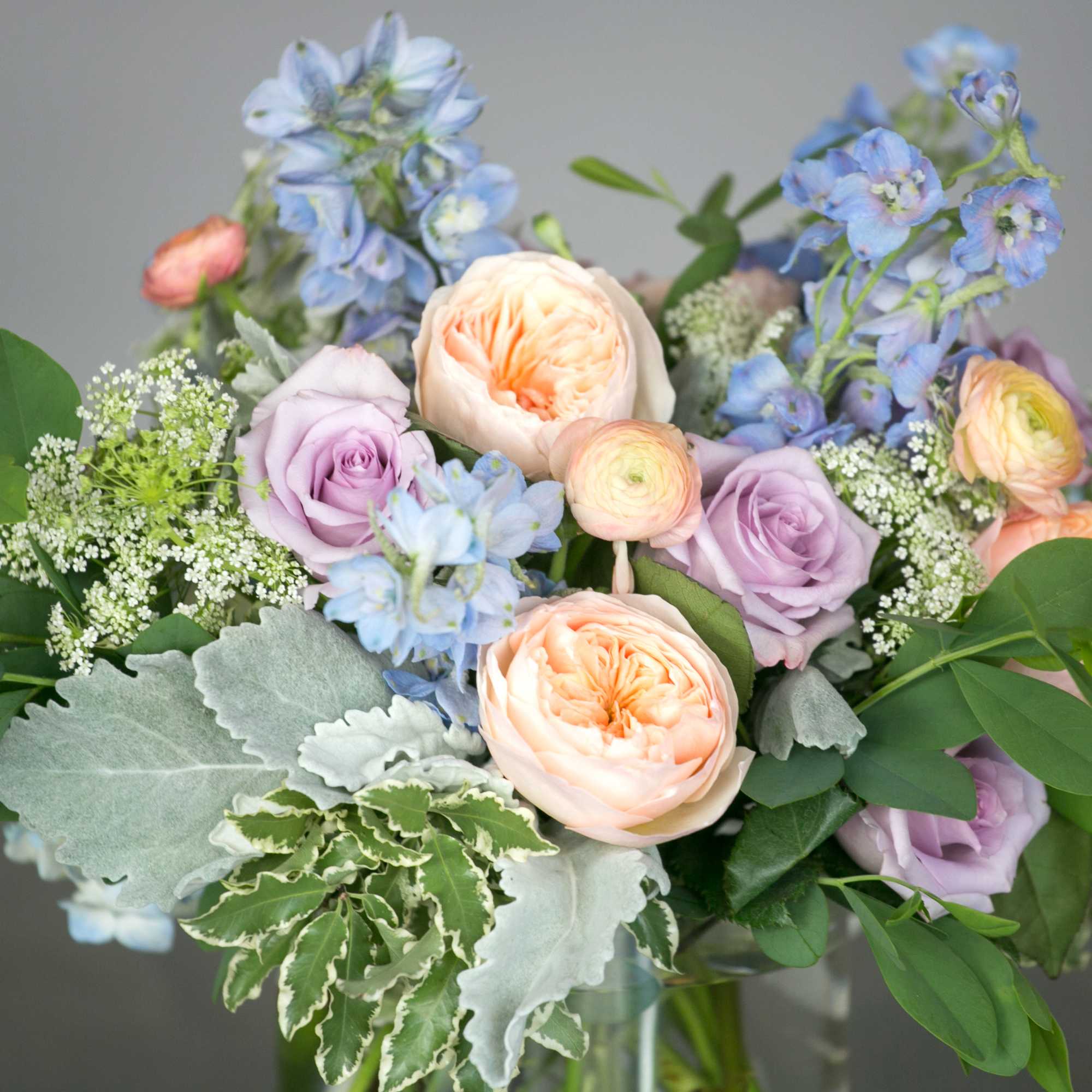 A soft gathering of blooms inspired by an English country garden. Delphinium
