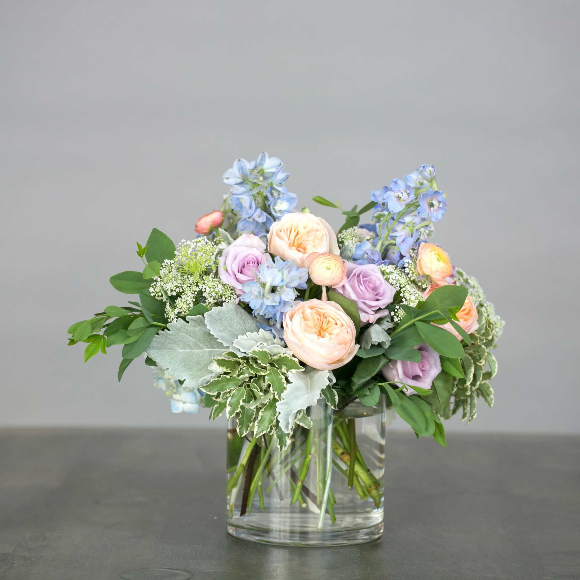 A soft gathering of blooms inspired by an English country garden. Delphinium