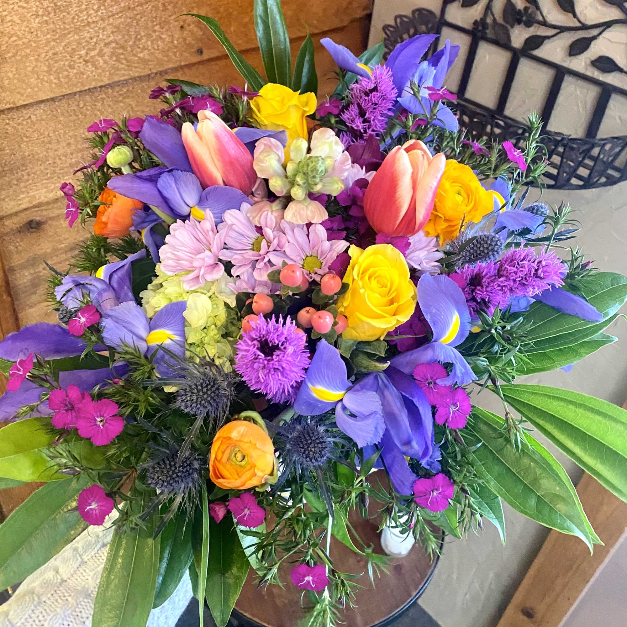 Colorful bouquet with tulips, roses, and purple blooms