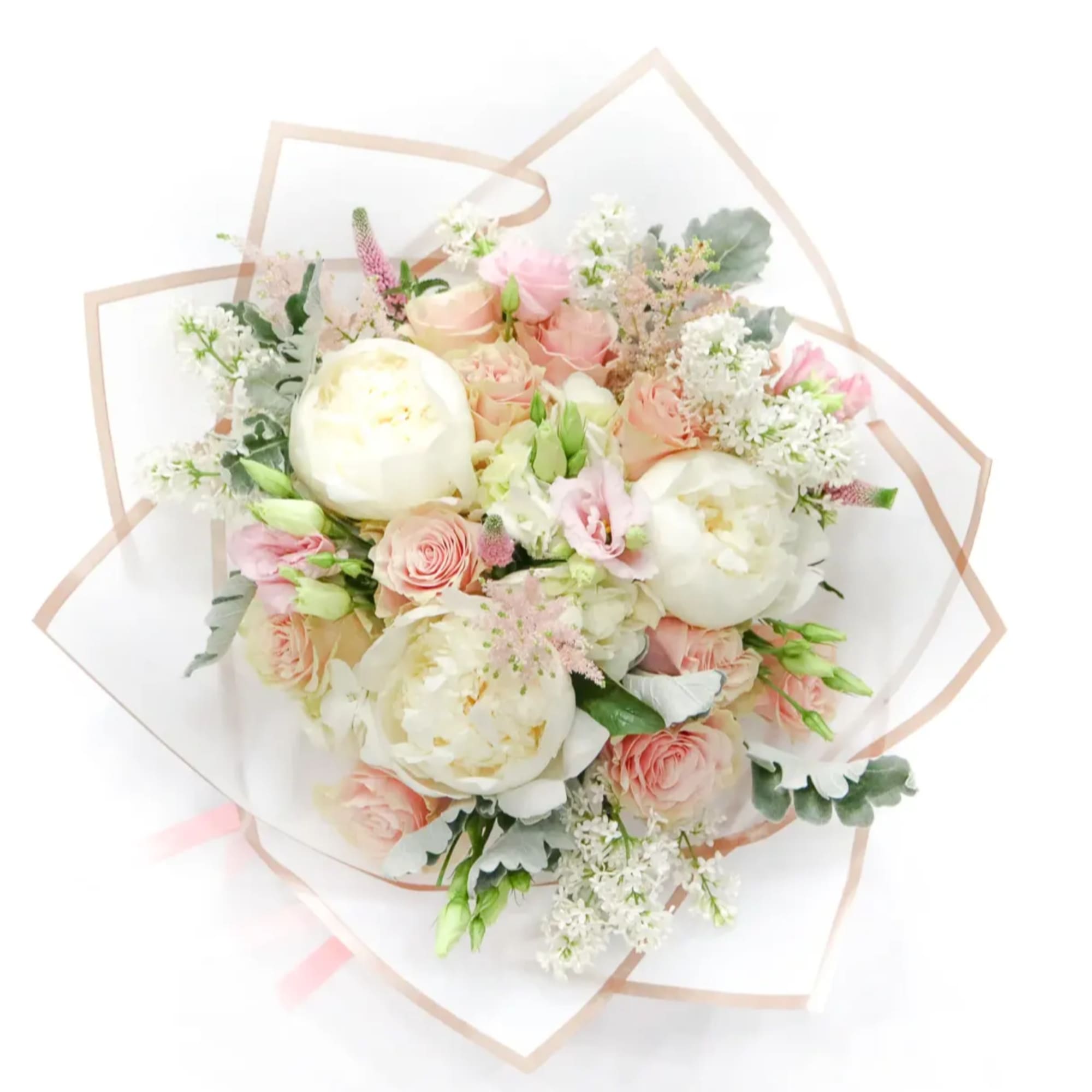 Bouquet of blush and white flowers wrapped in clear paper