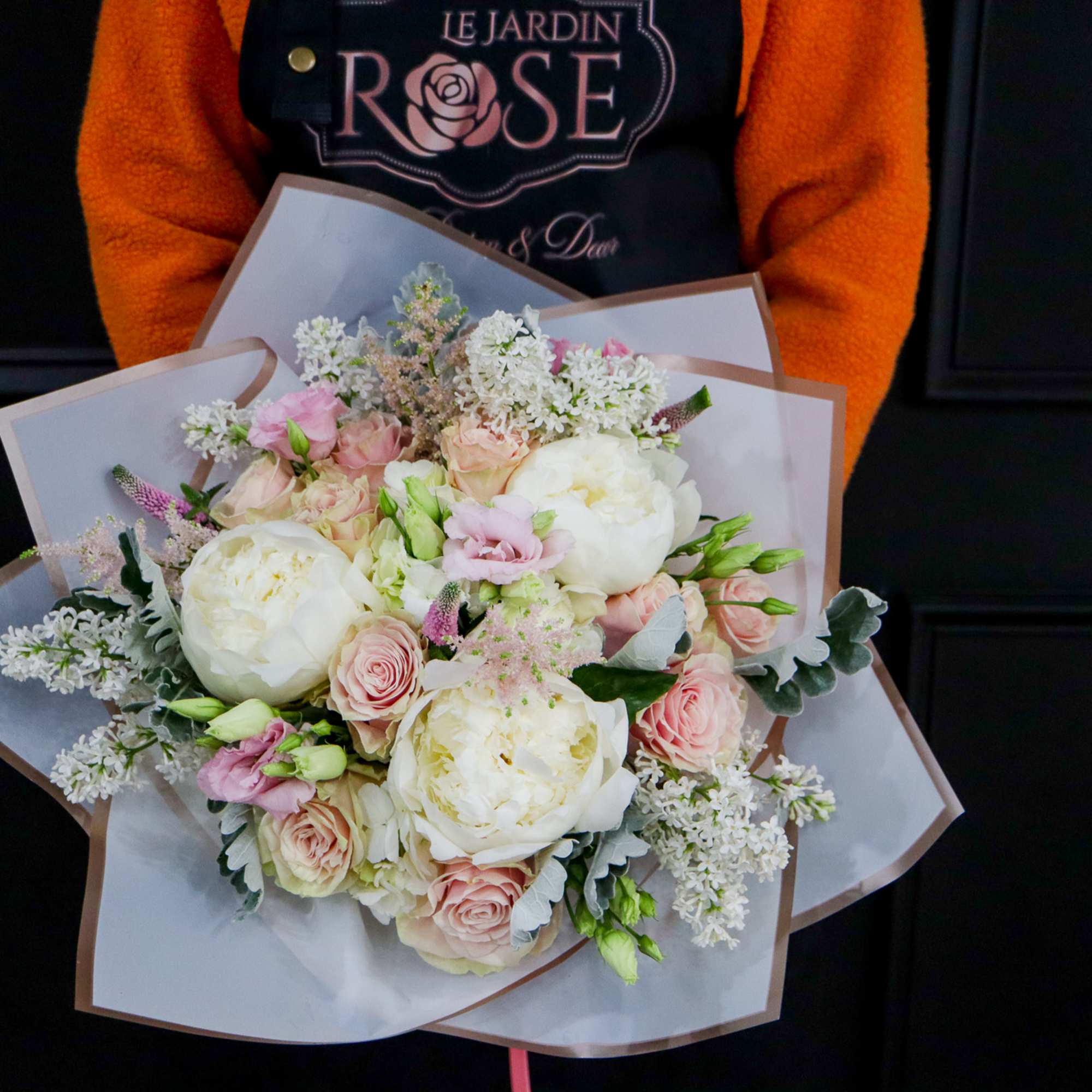 Bouquet of white and blush flowers wrapped in paper