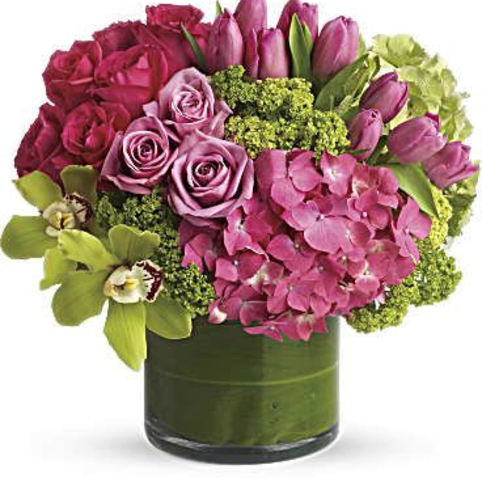A lively burst of pinks and lime-green, this floral arrangement is a
