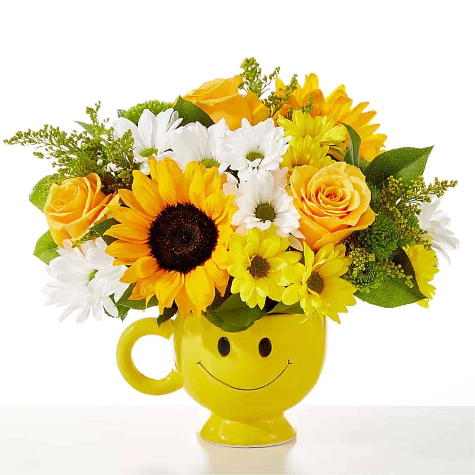 Yellow sunflower, rose and daisy arrangement in a yellow smiley-face ceramic mug.