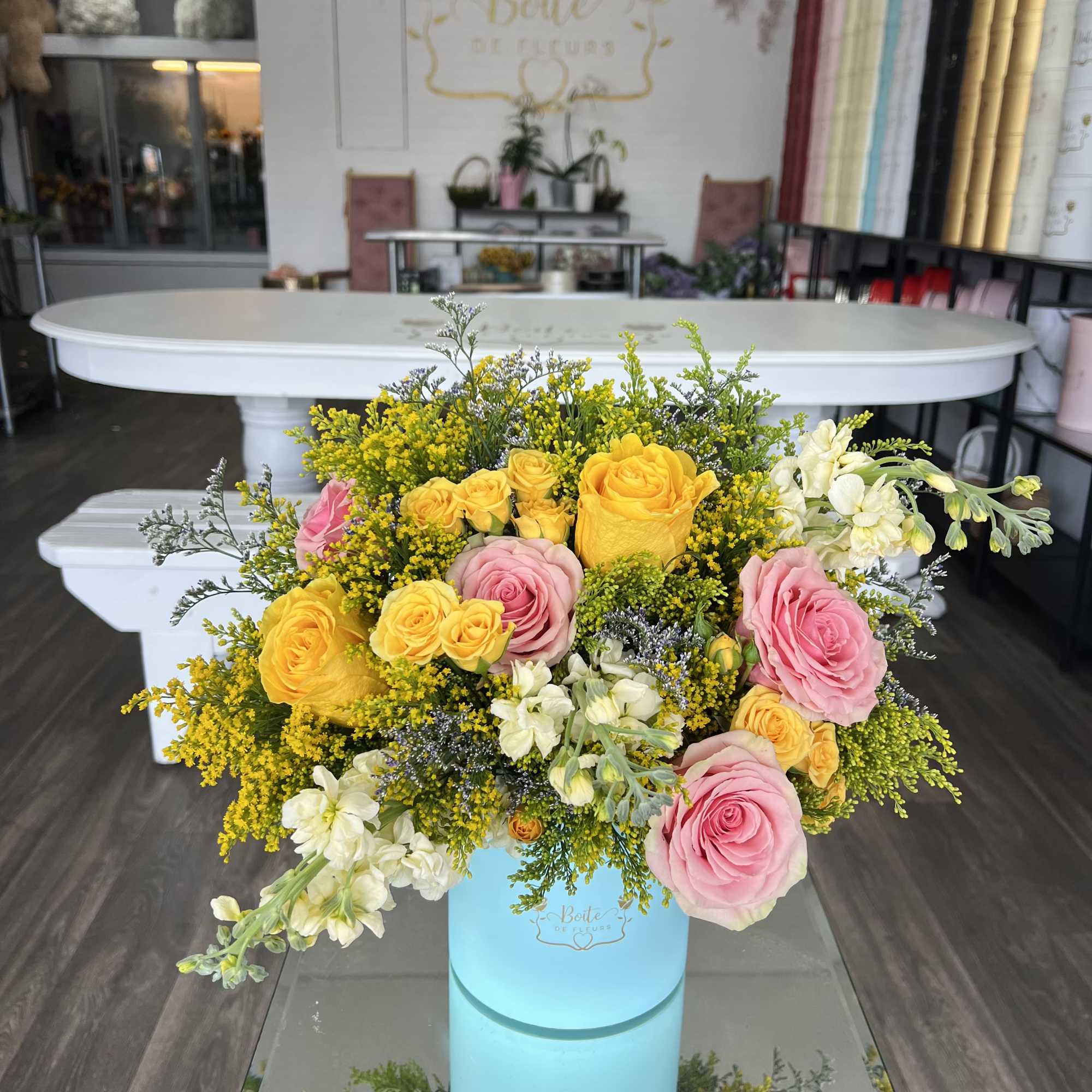 A vibrant blend of yellow sunflowers and ivory roses arranged in a