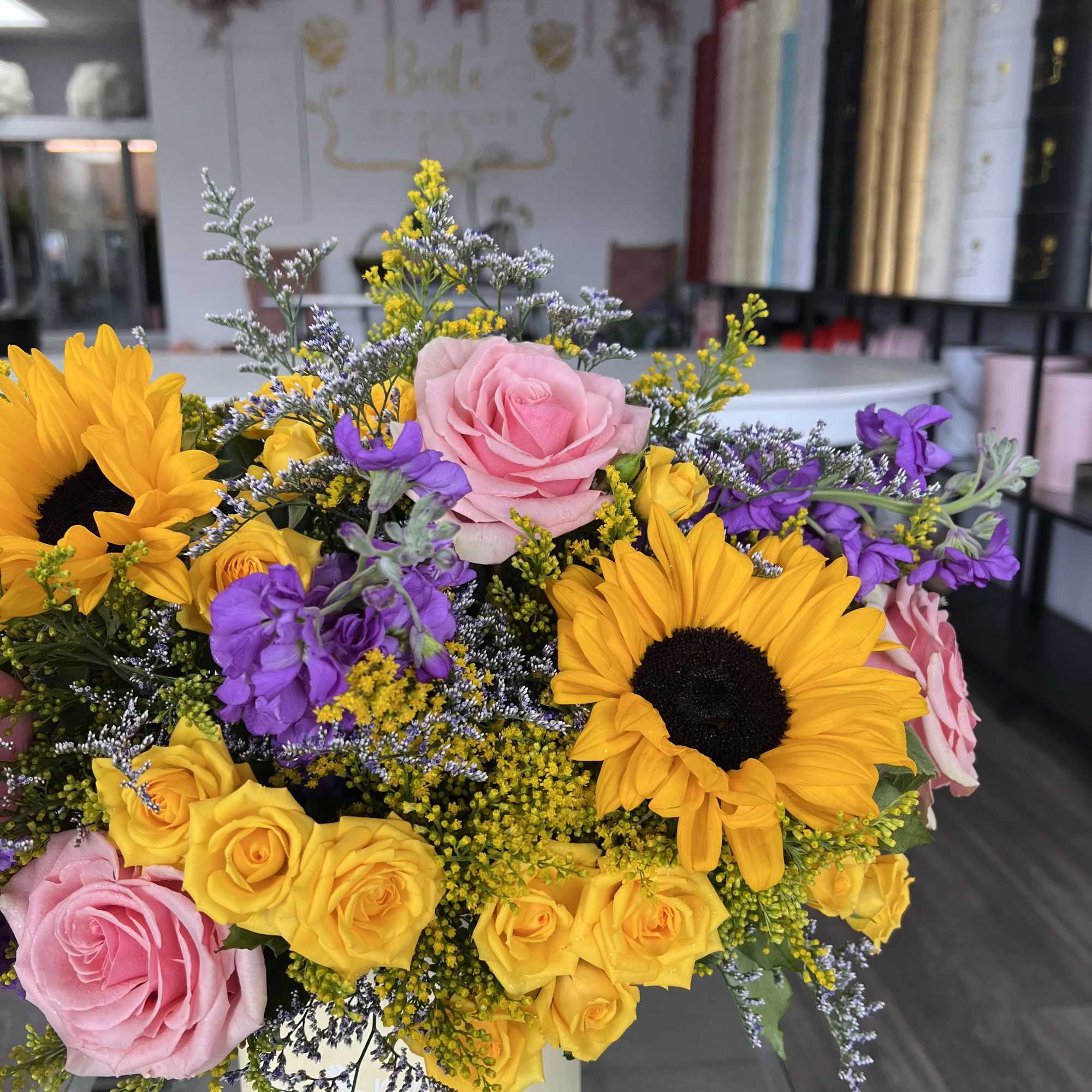 A little box of sunshine with a playful twist. Bursting with sunflowers