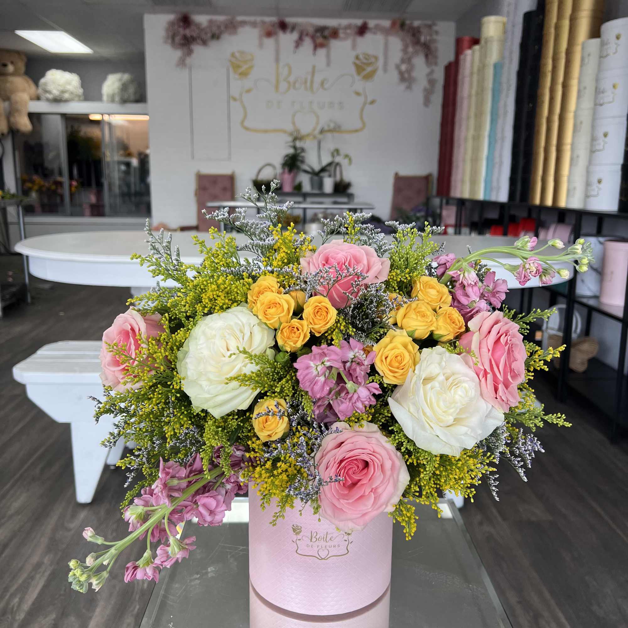 A soft blend of blush, yellow, and ivory roses arranged in a