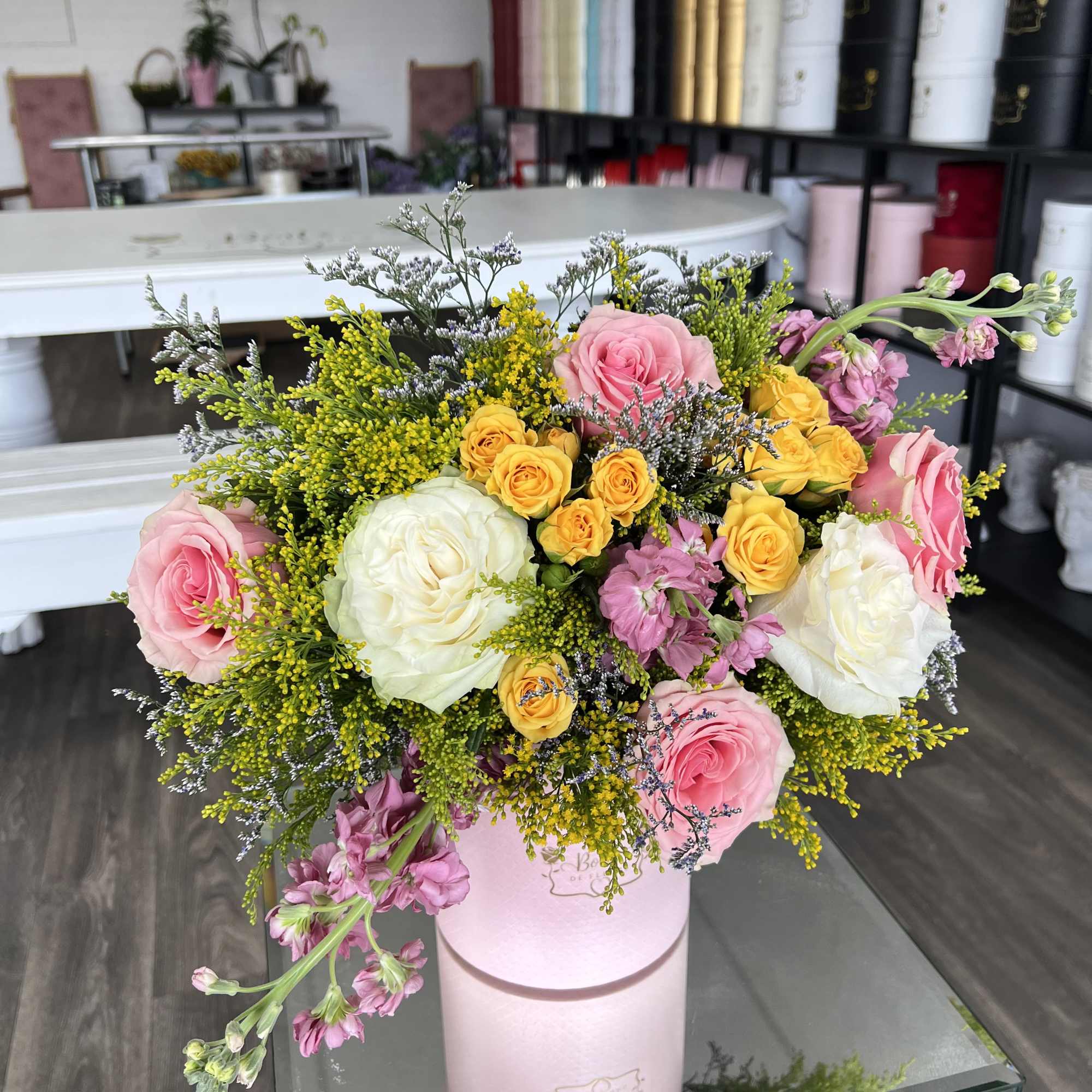 A soft blend of blush, yellow, and ivory roses arranged in a