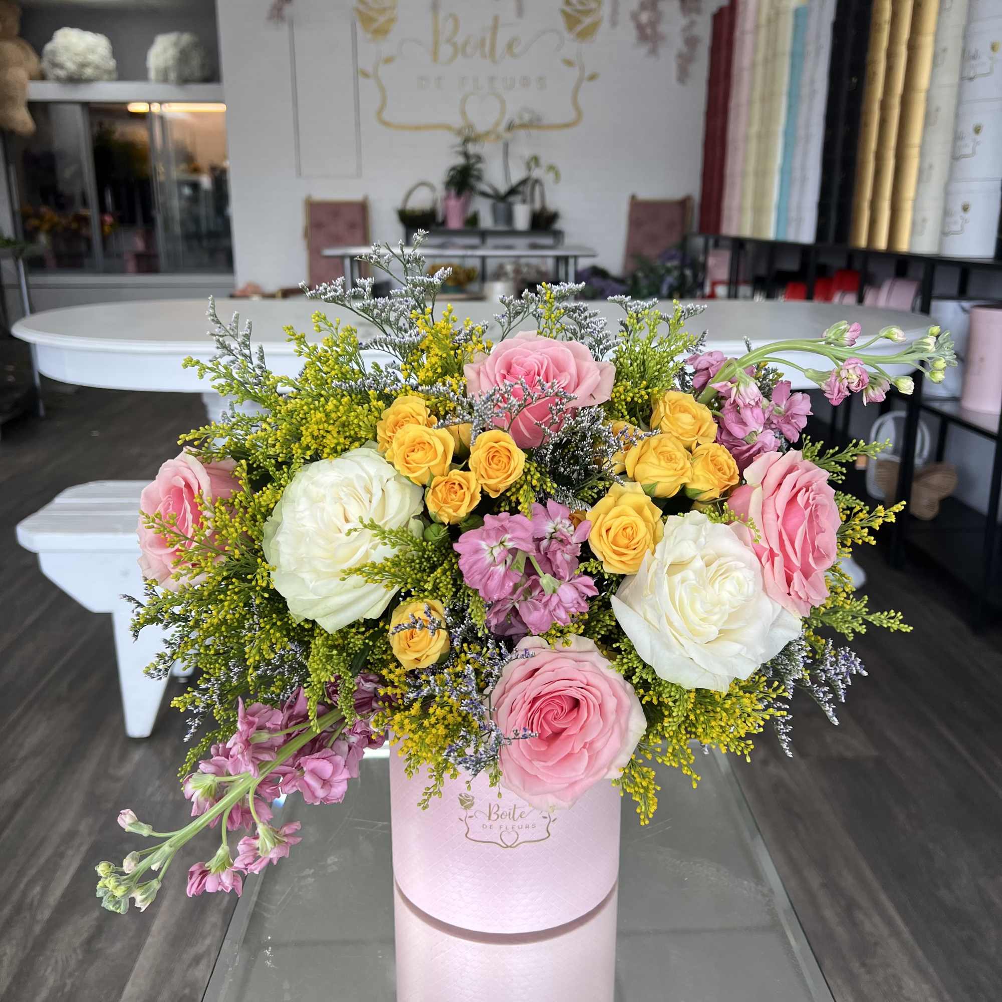 A soft blend of blush, yellow, and ivory roses arranged in a