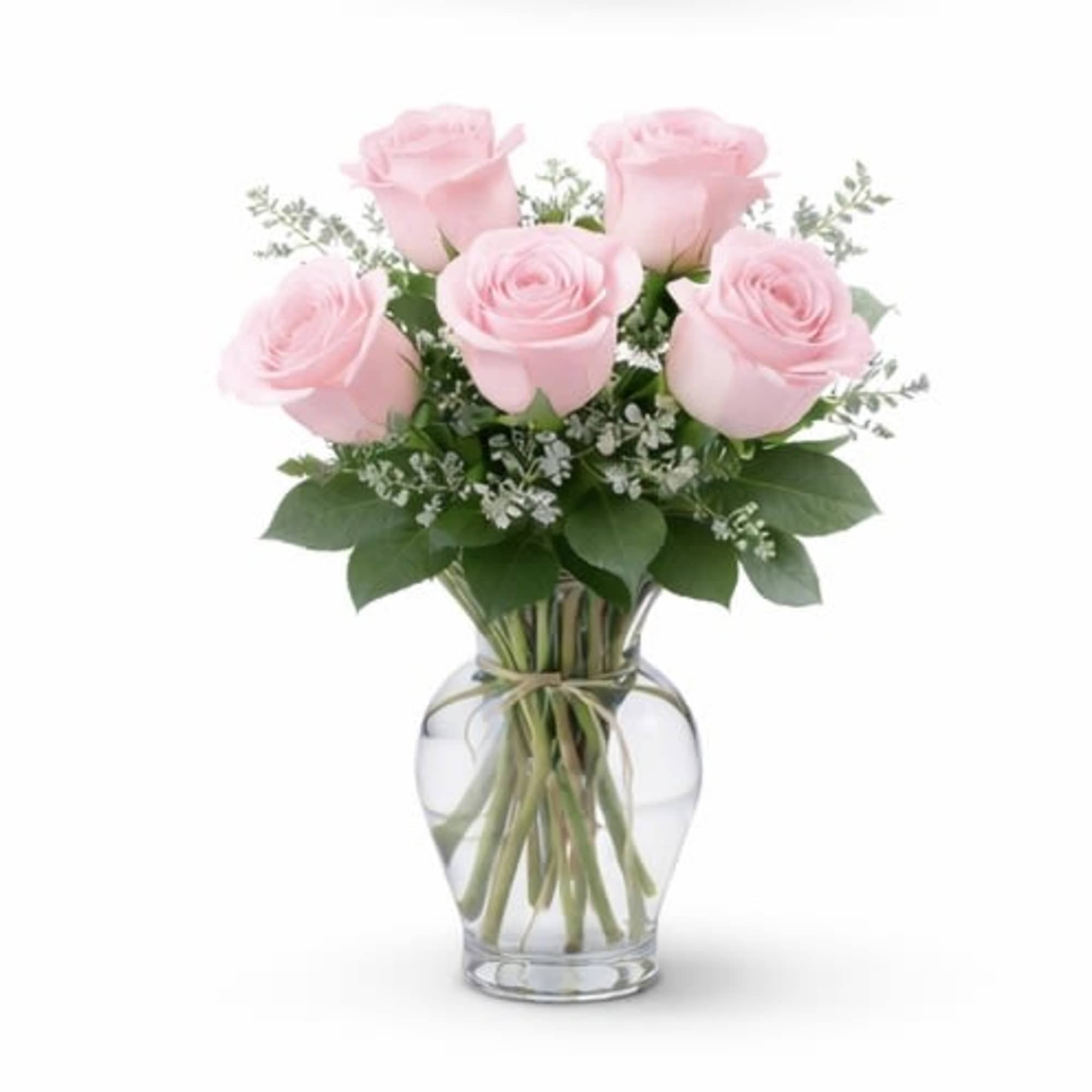 Pink roses arranged in a clear glass vase