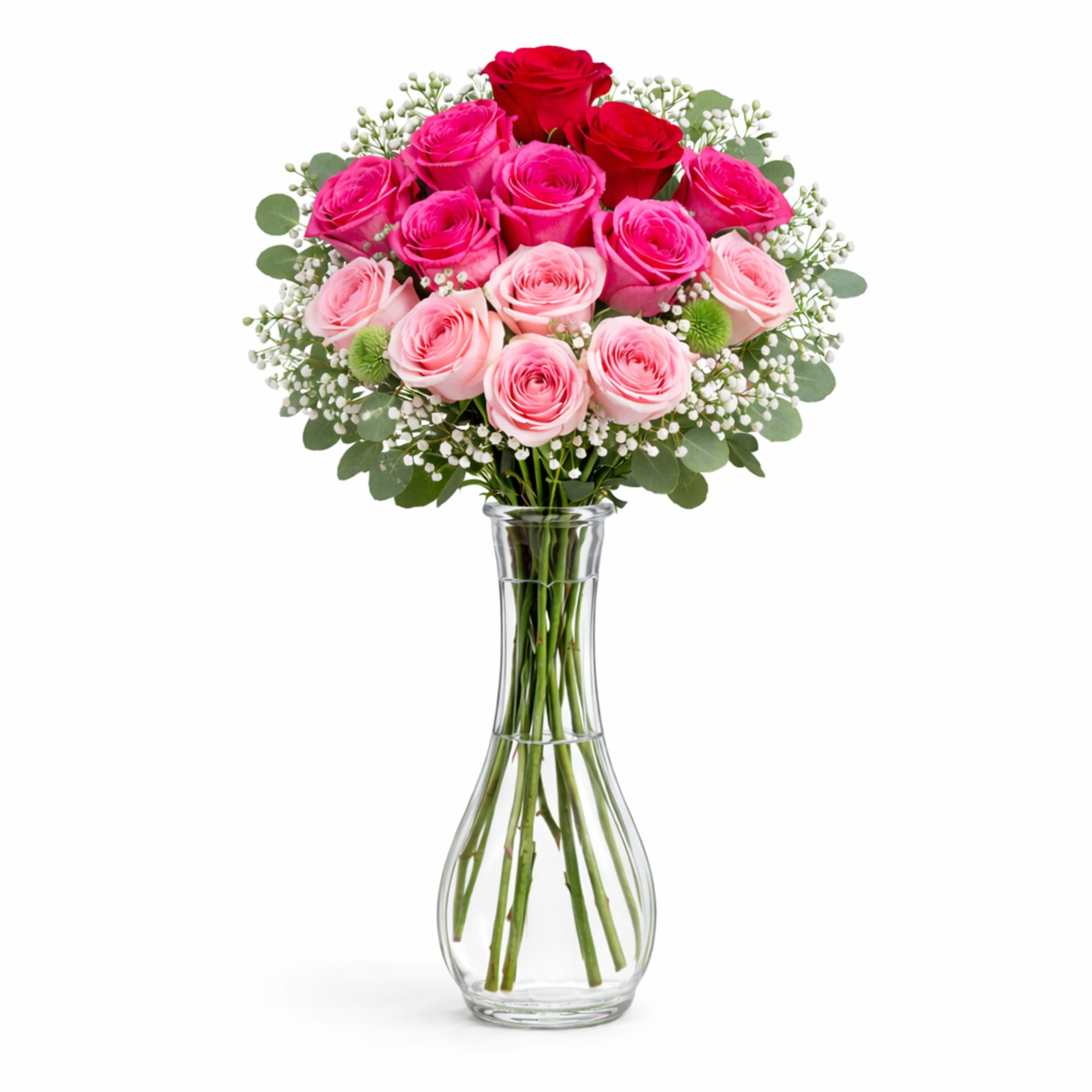 Pink and red roses arranged in a clear glass vase