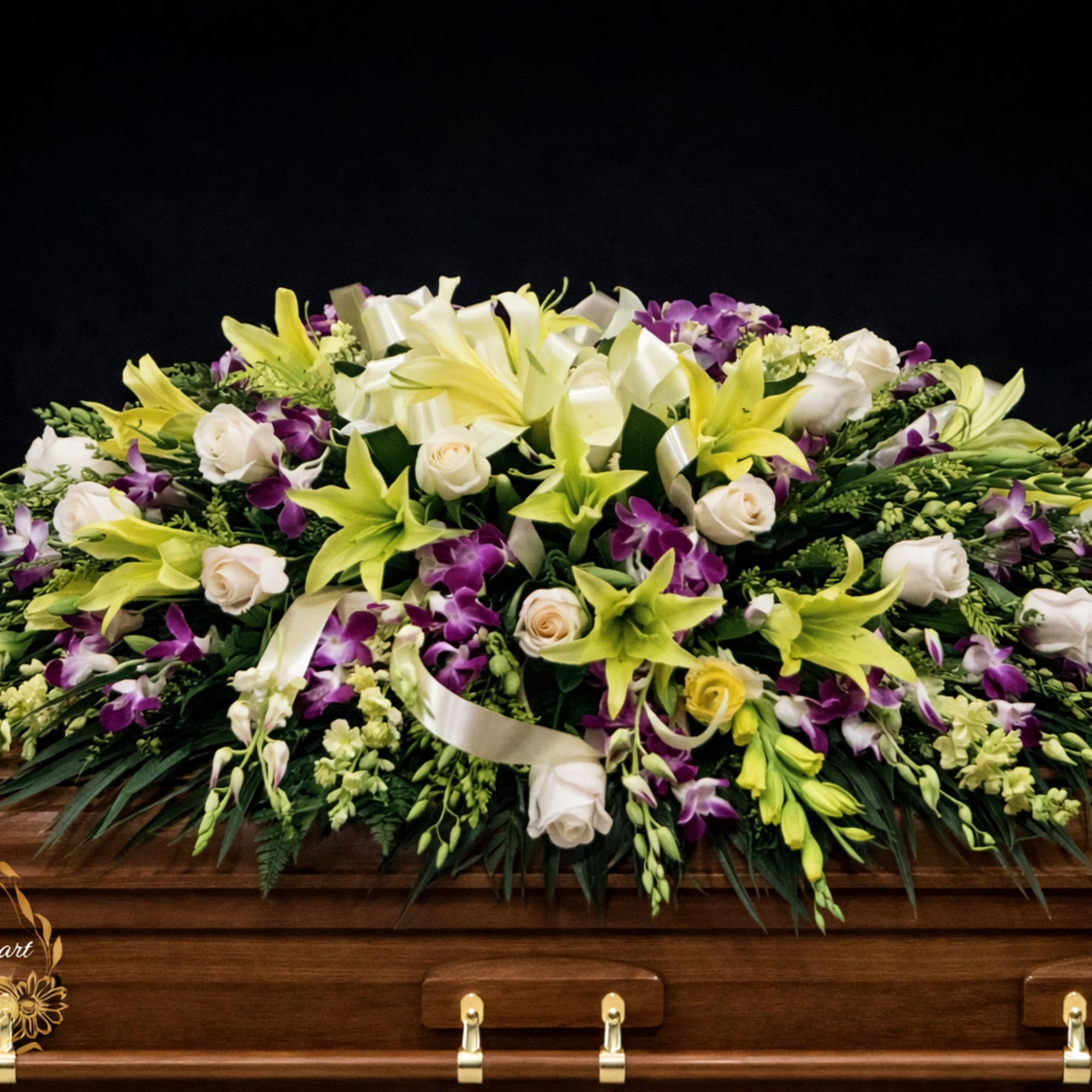 This casket spray make with purple dendrobium orchids and yellow wind lily
