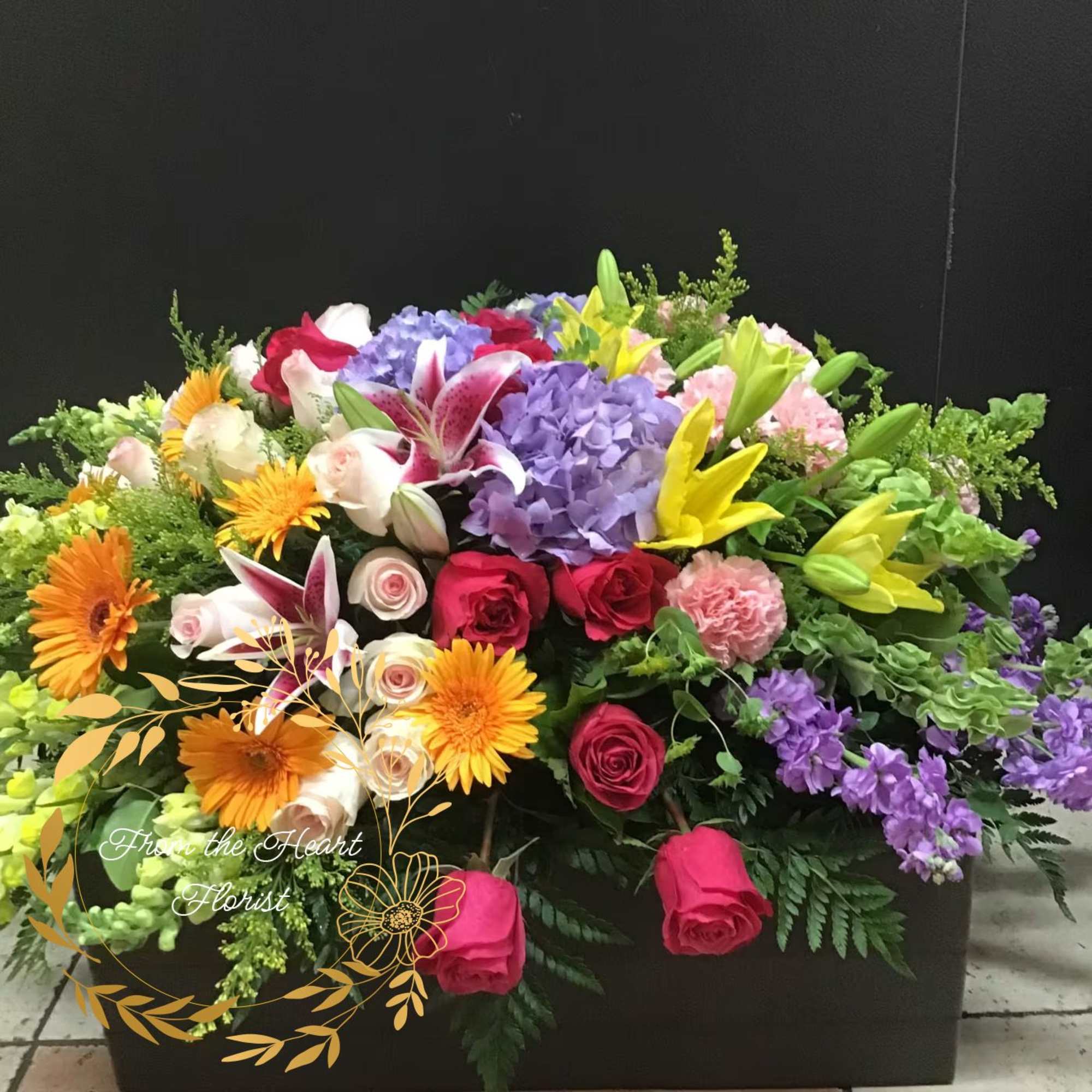 Large mixed flower arrangement with roses, lilies, hydrangeas, and gerbera daisies
