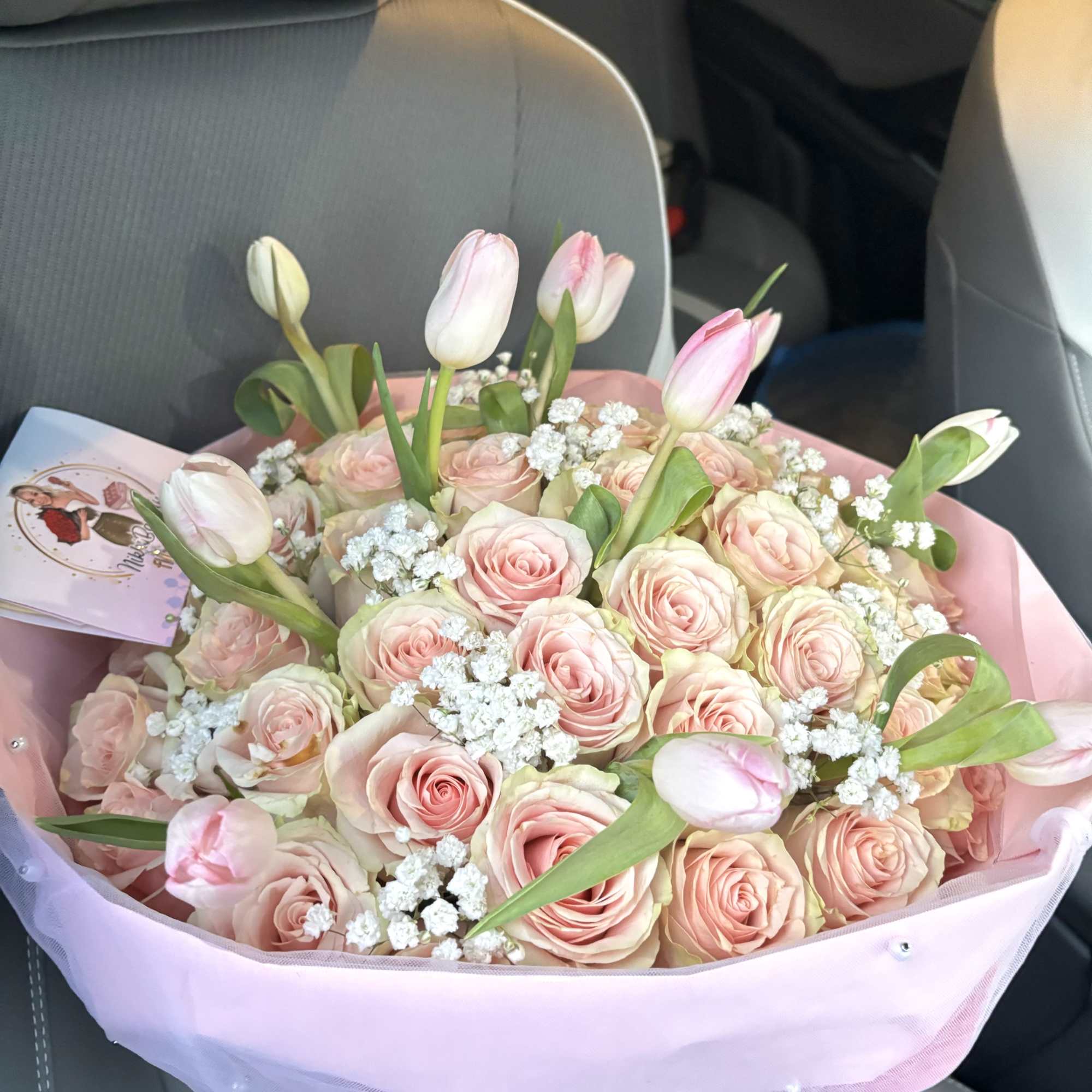 Pink rose and tulip bouquet wrapped in pastel paper