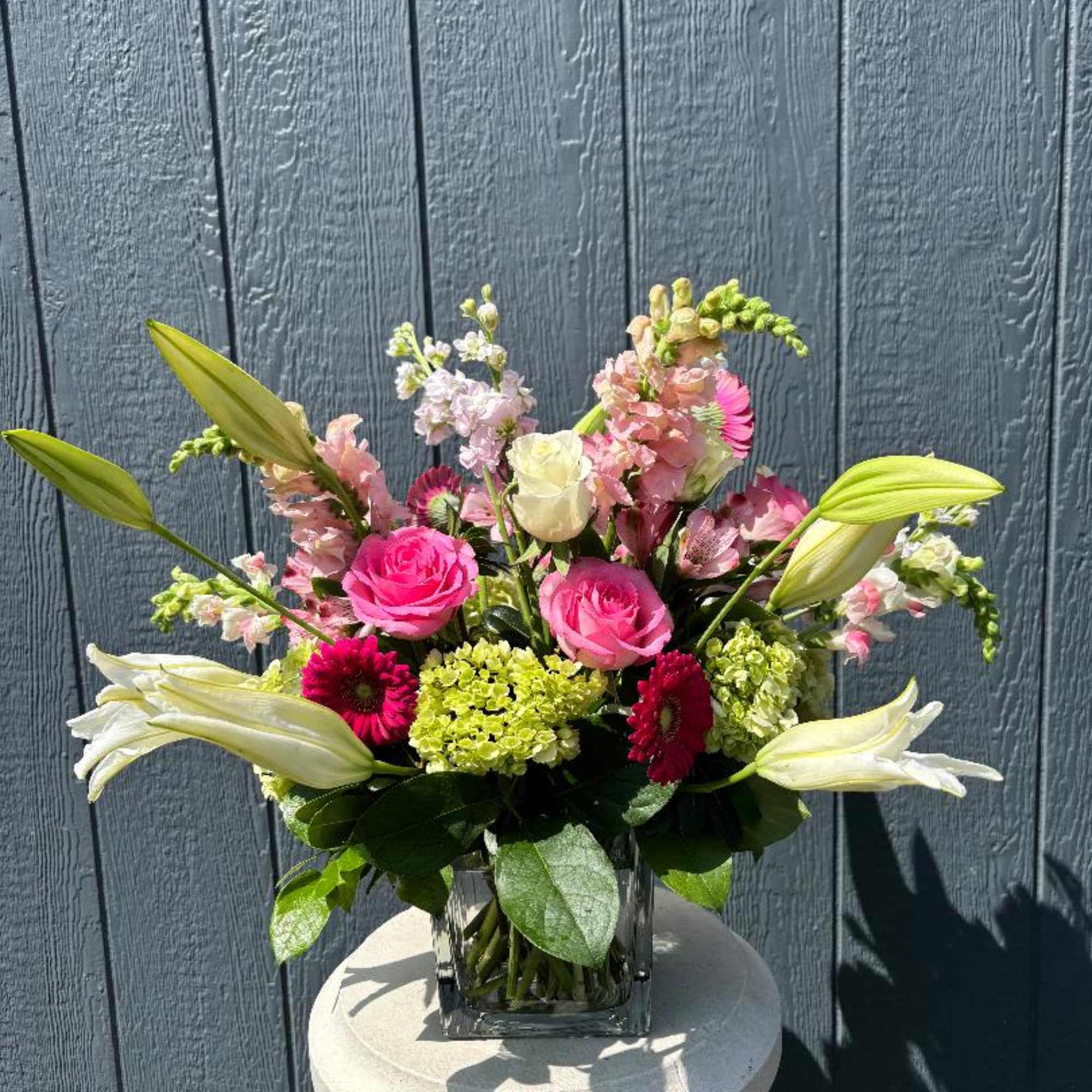A beautiful burst of Lilies, Roses, Snapdragons, Stock, Gerbera and Green Hydrangea