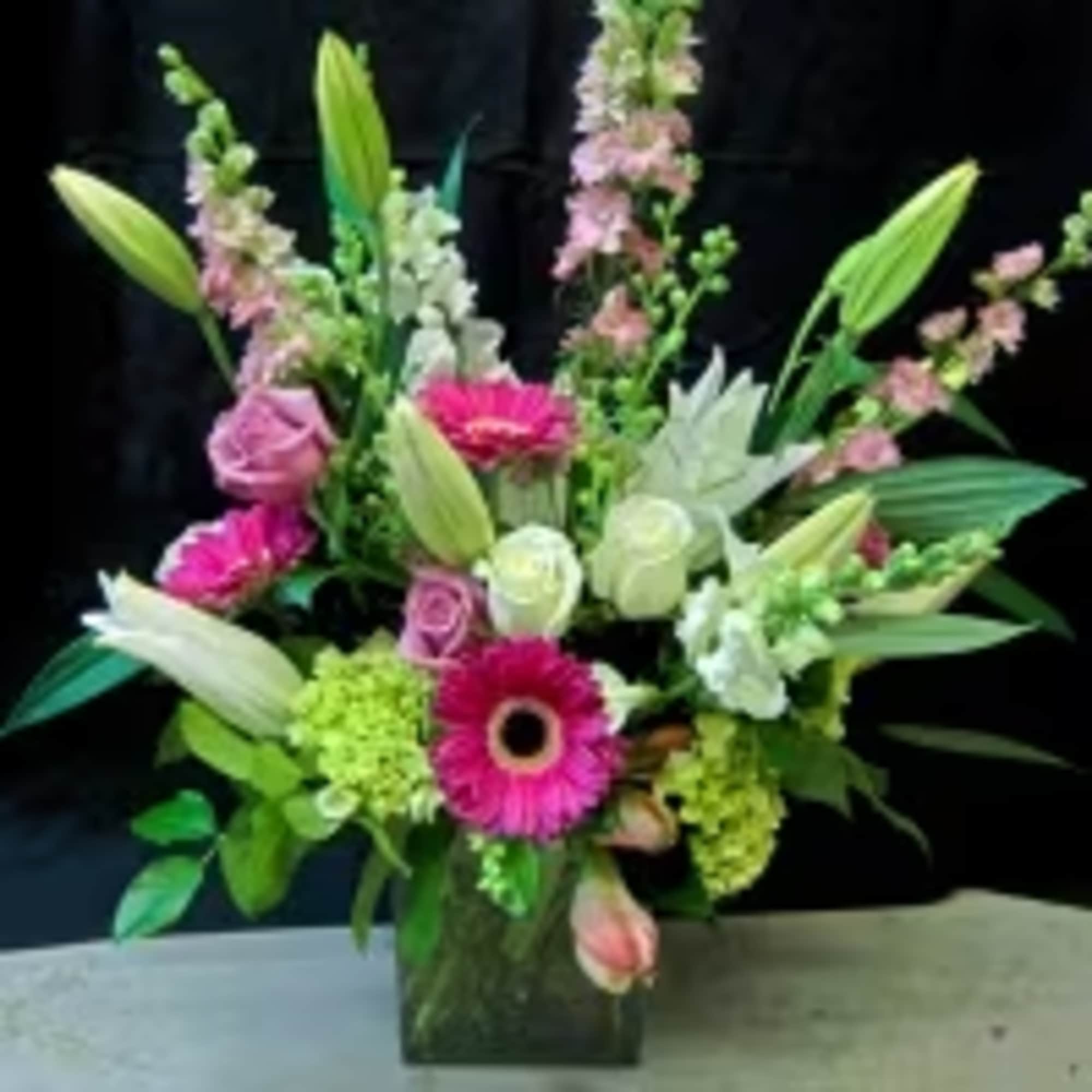 A beautiful burst of Lilies, Roses, Snapdragons, Stock, Gerbera and Green Hydrangea