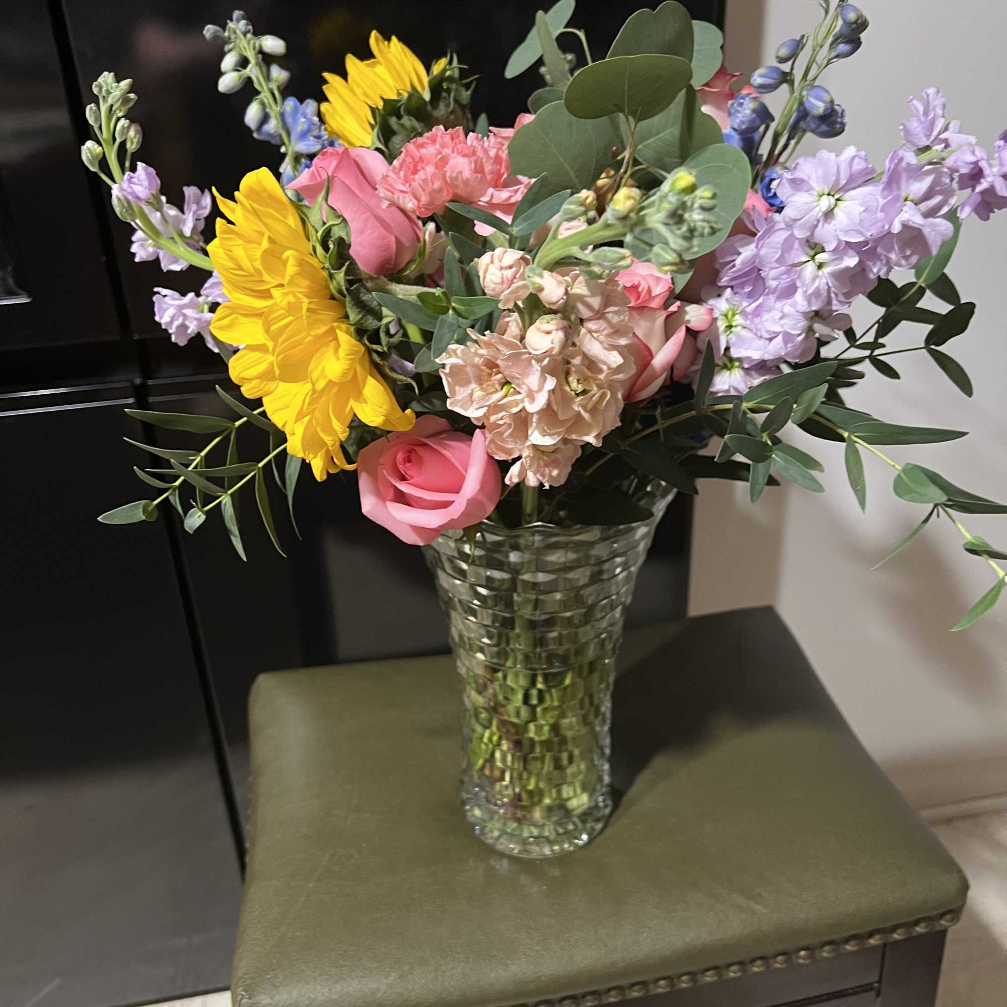 Sunflowers and pink roses take center stage in this Spring Time flower