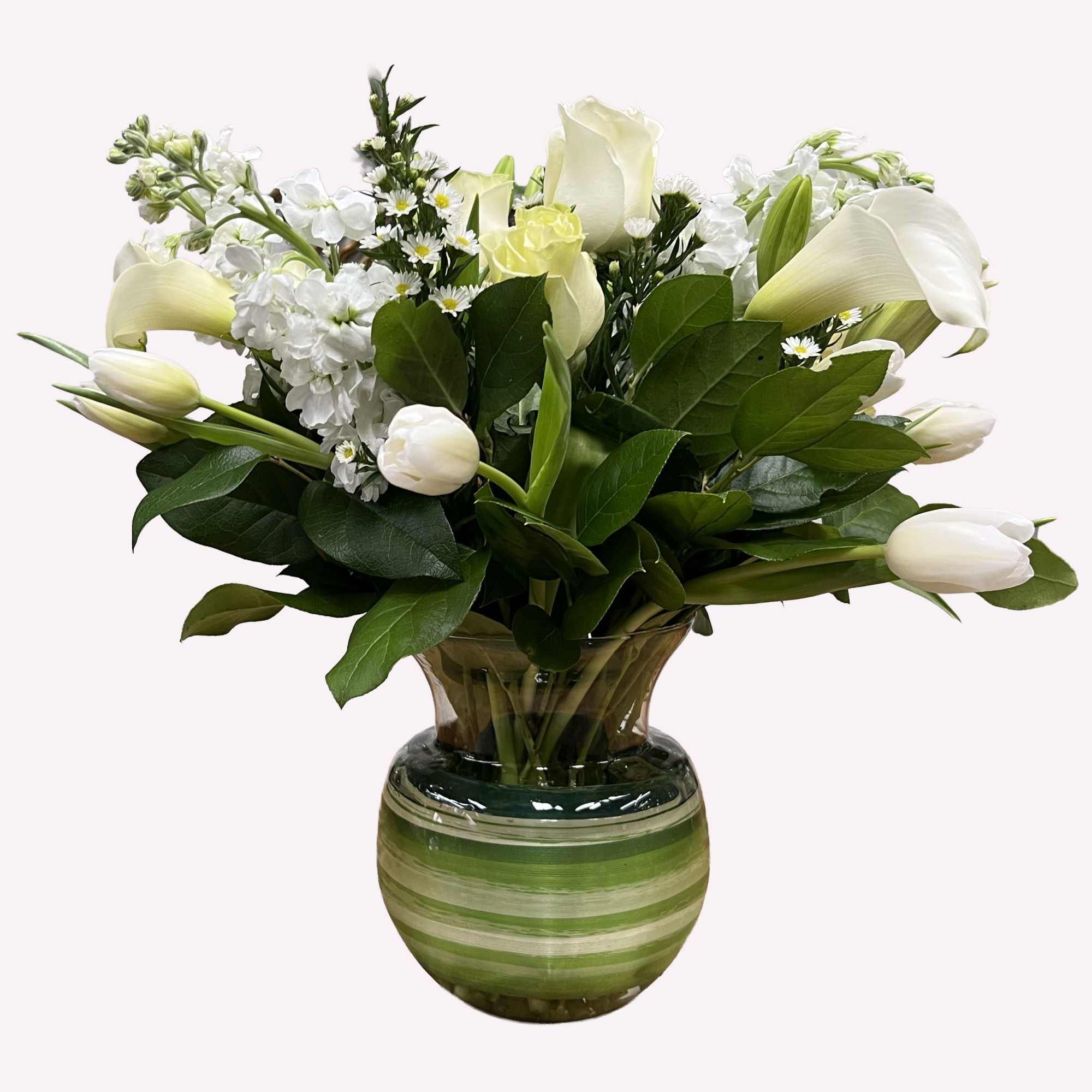 White tulips and calla lilies in a green striped vase