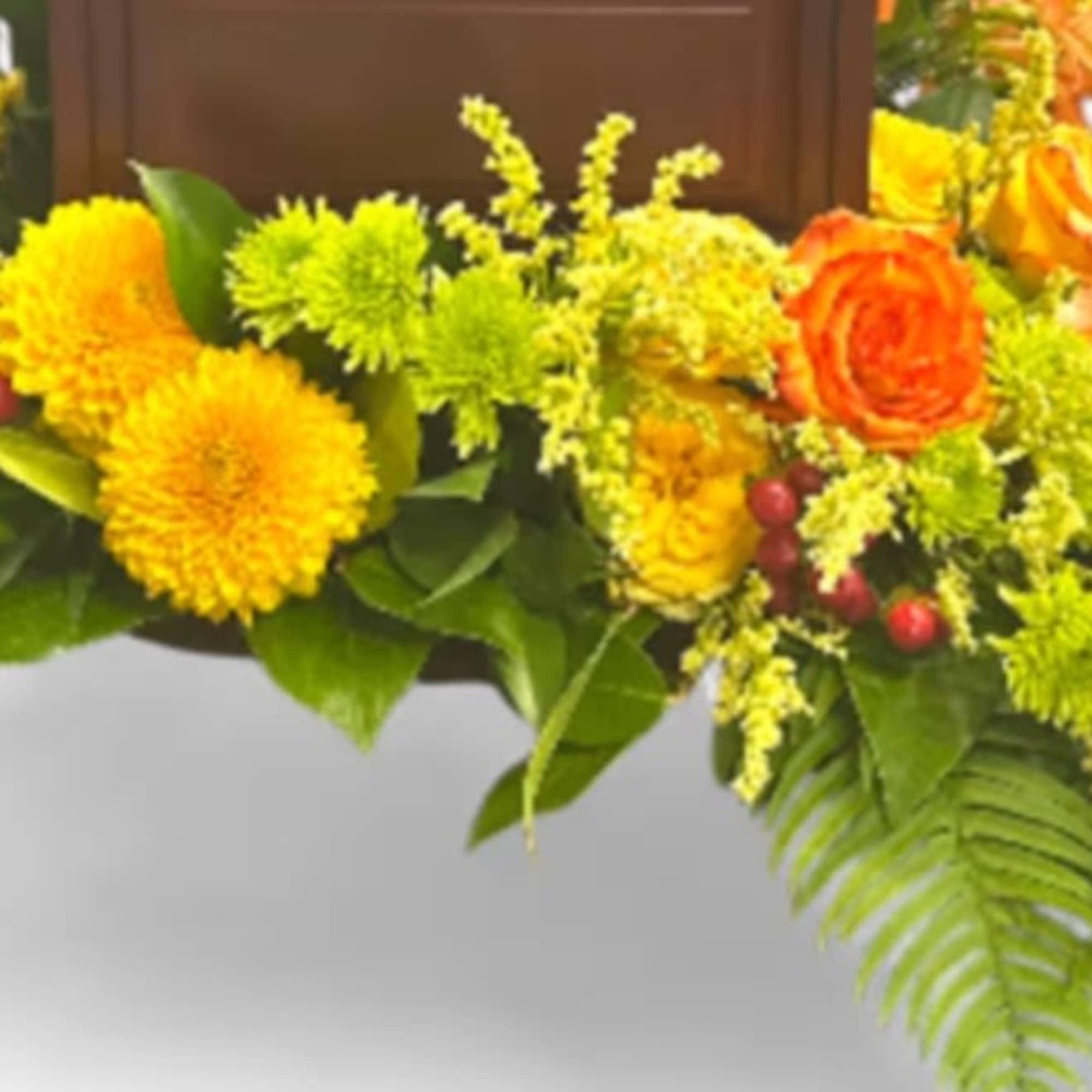 This vibrant sympathy arrangement, thoughtfully presented in an 8-inch design tray, offers