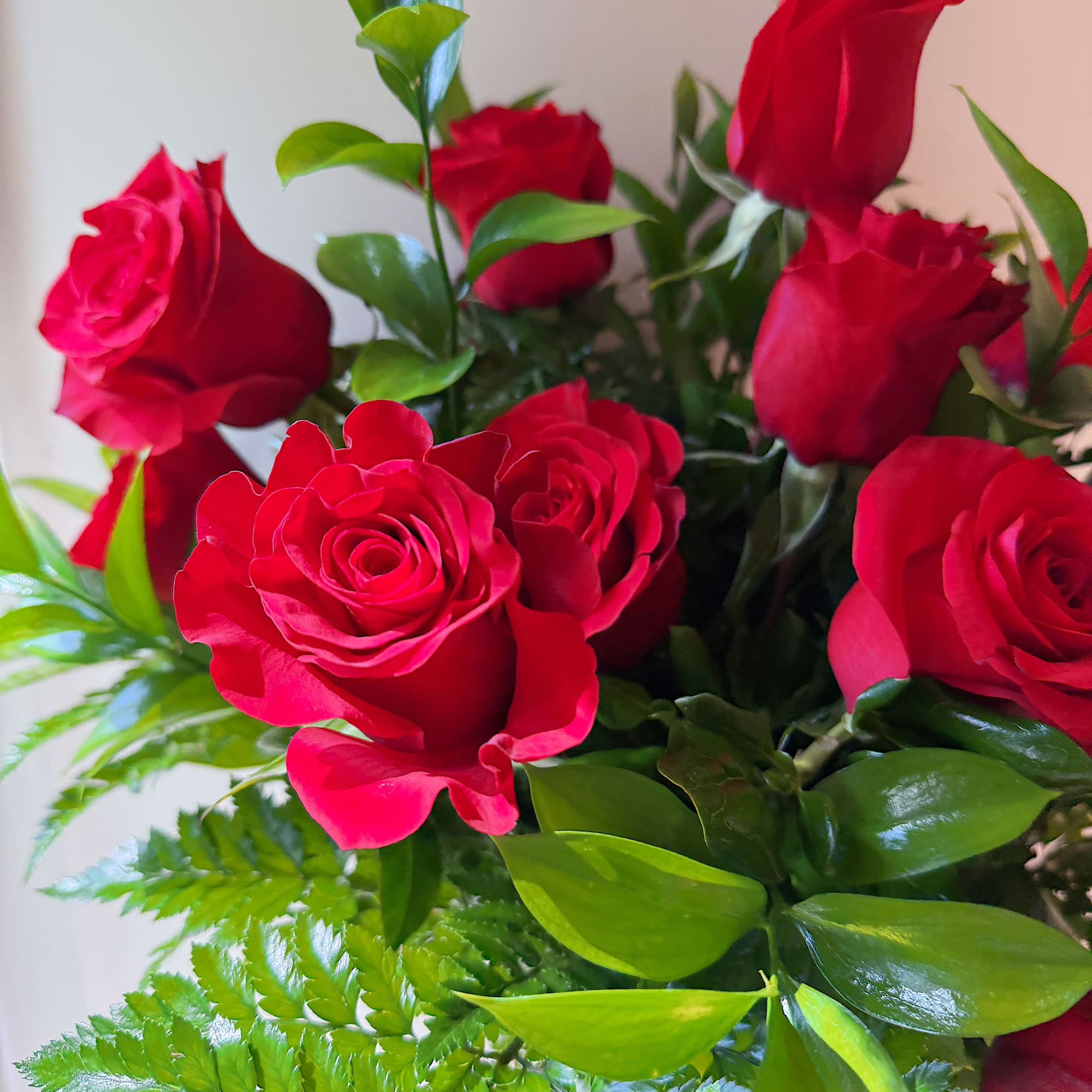 Bouquet of red roses with green foliage