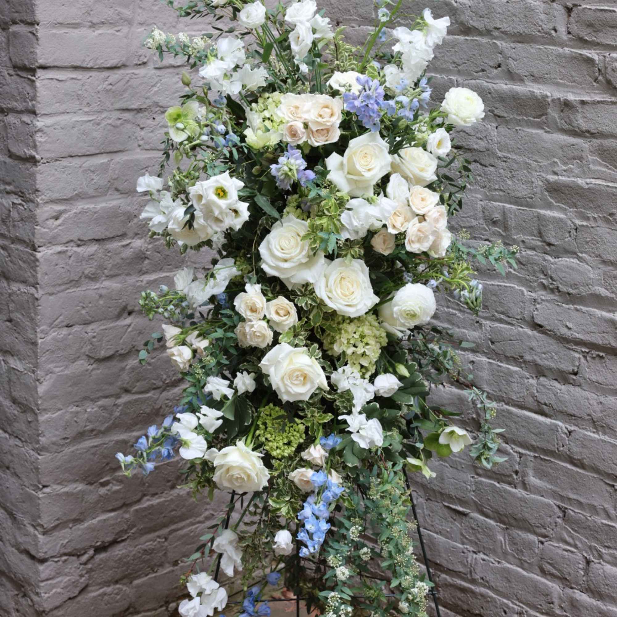An exquisite standing display of flowers to celebrate the life of your