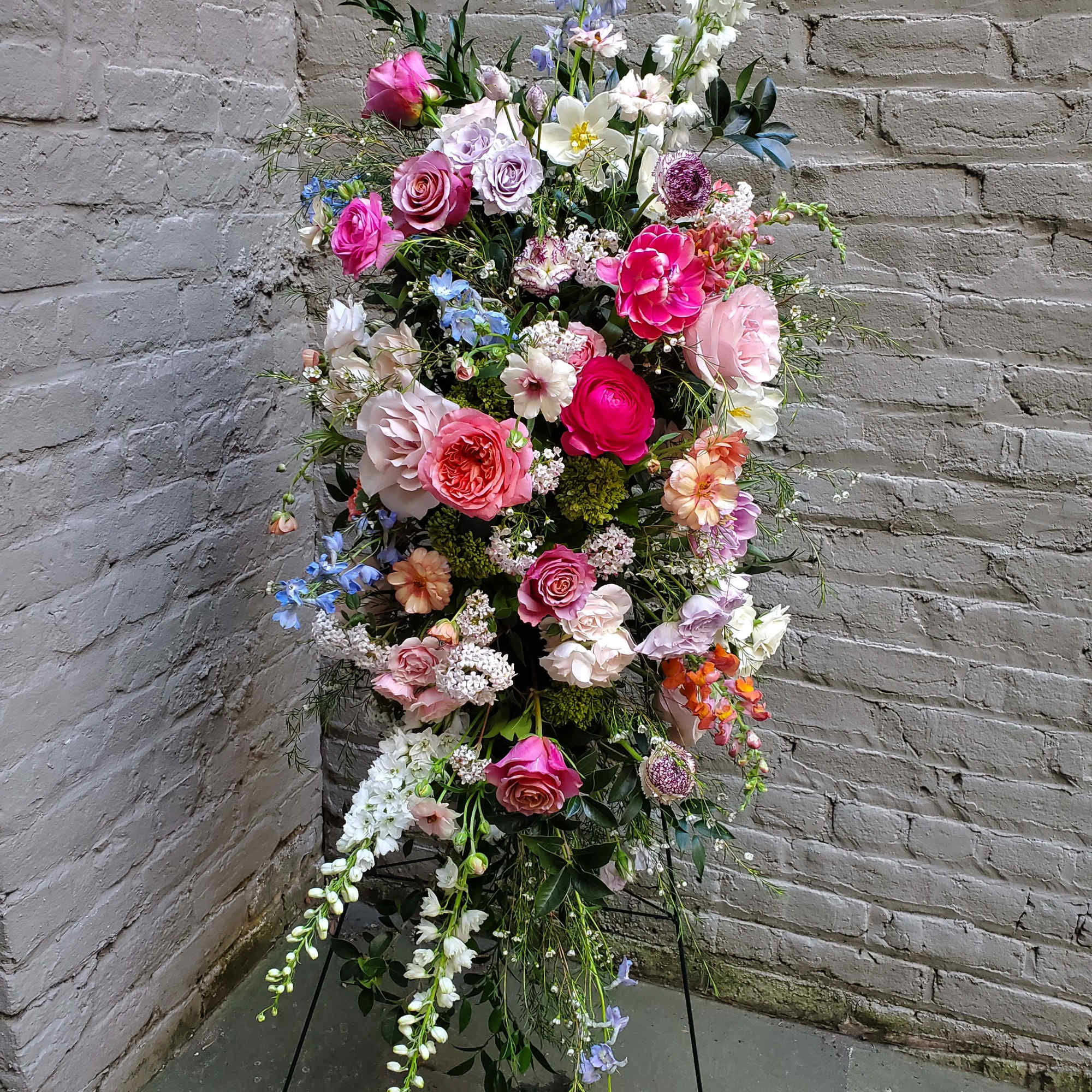 An exquisite standing display of flowers to celebrate the life of your