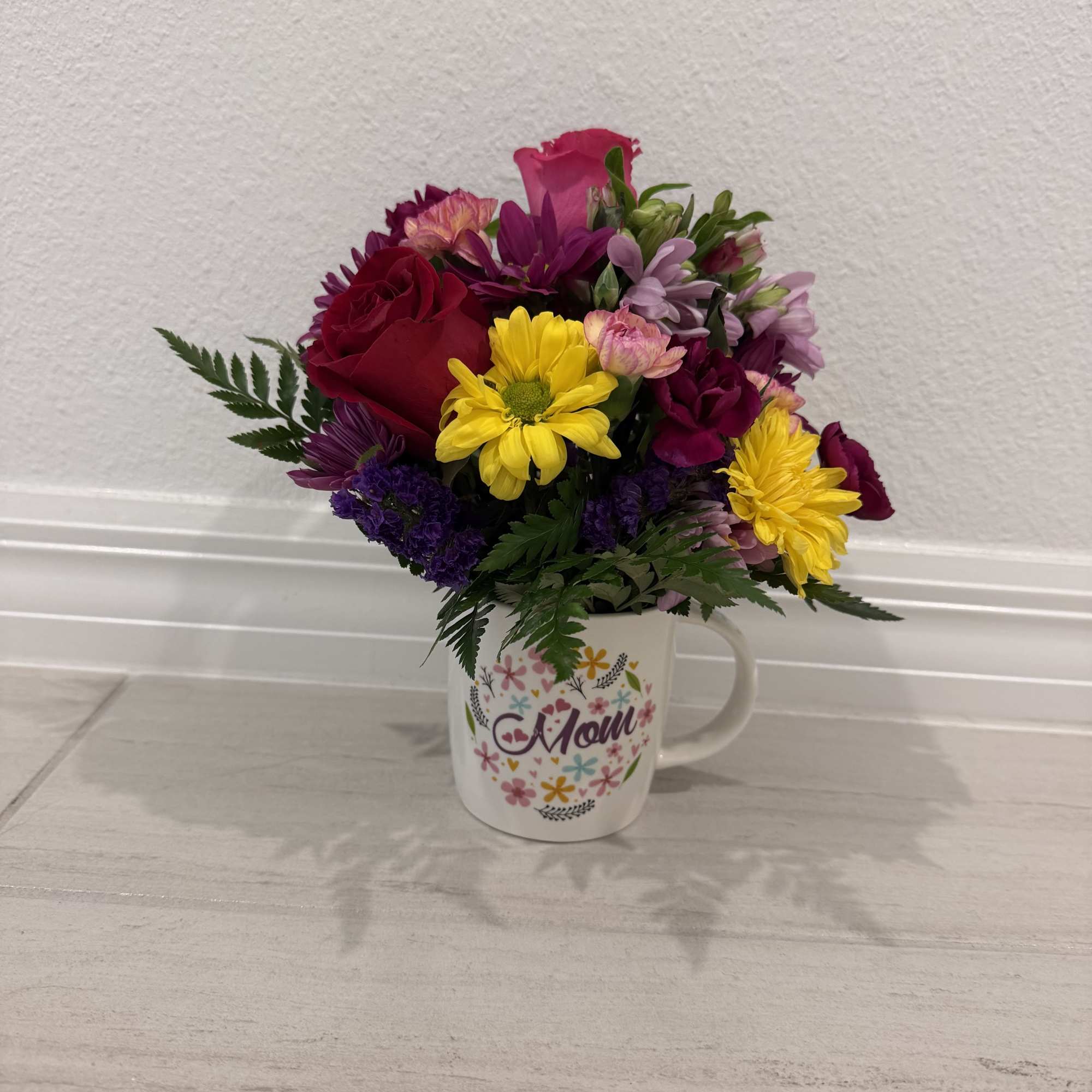 A beautiful &ldquo;Happy Mother&rsquo;s Day&rdquo; mug with fresh flowers&mdash;perfect to brighten her