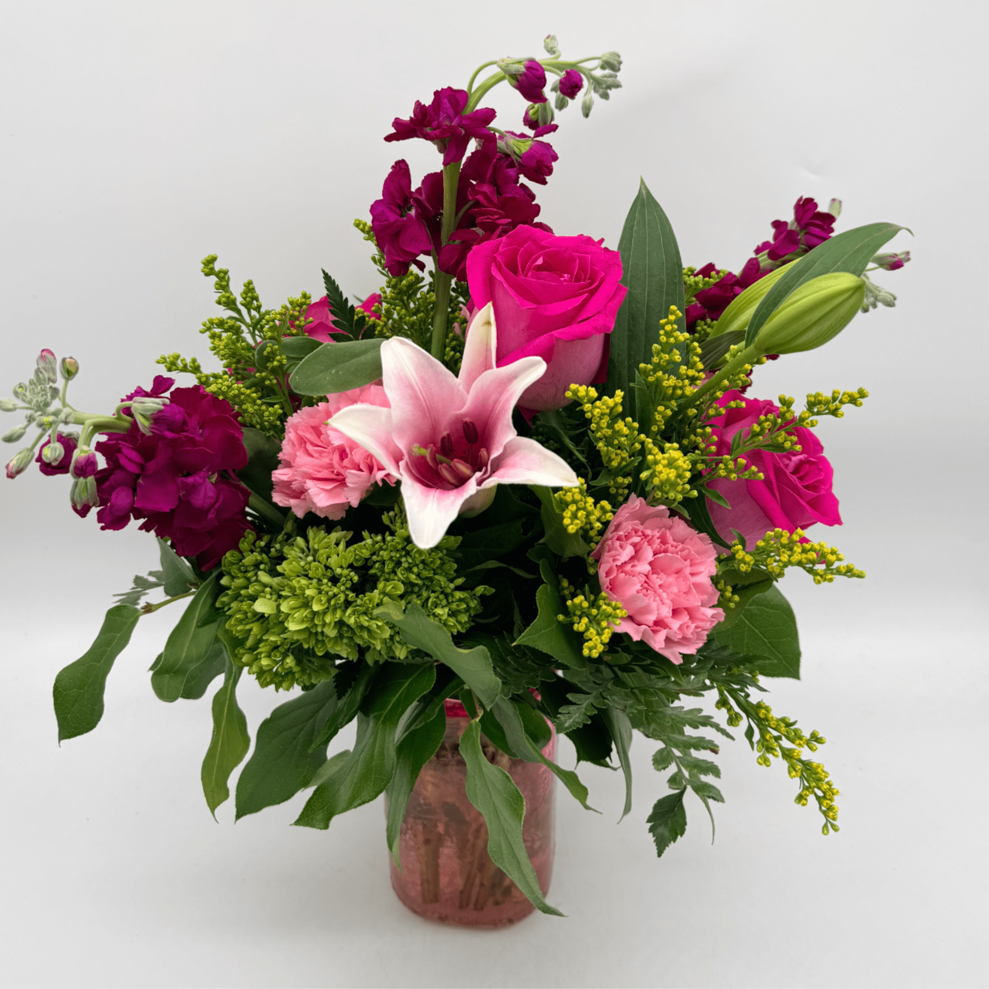 Fun, flirty, and full of color, this bouquet showcases roses, a lily
