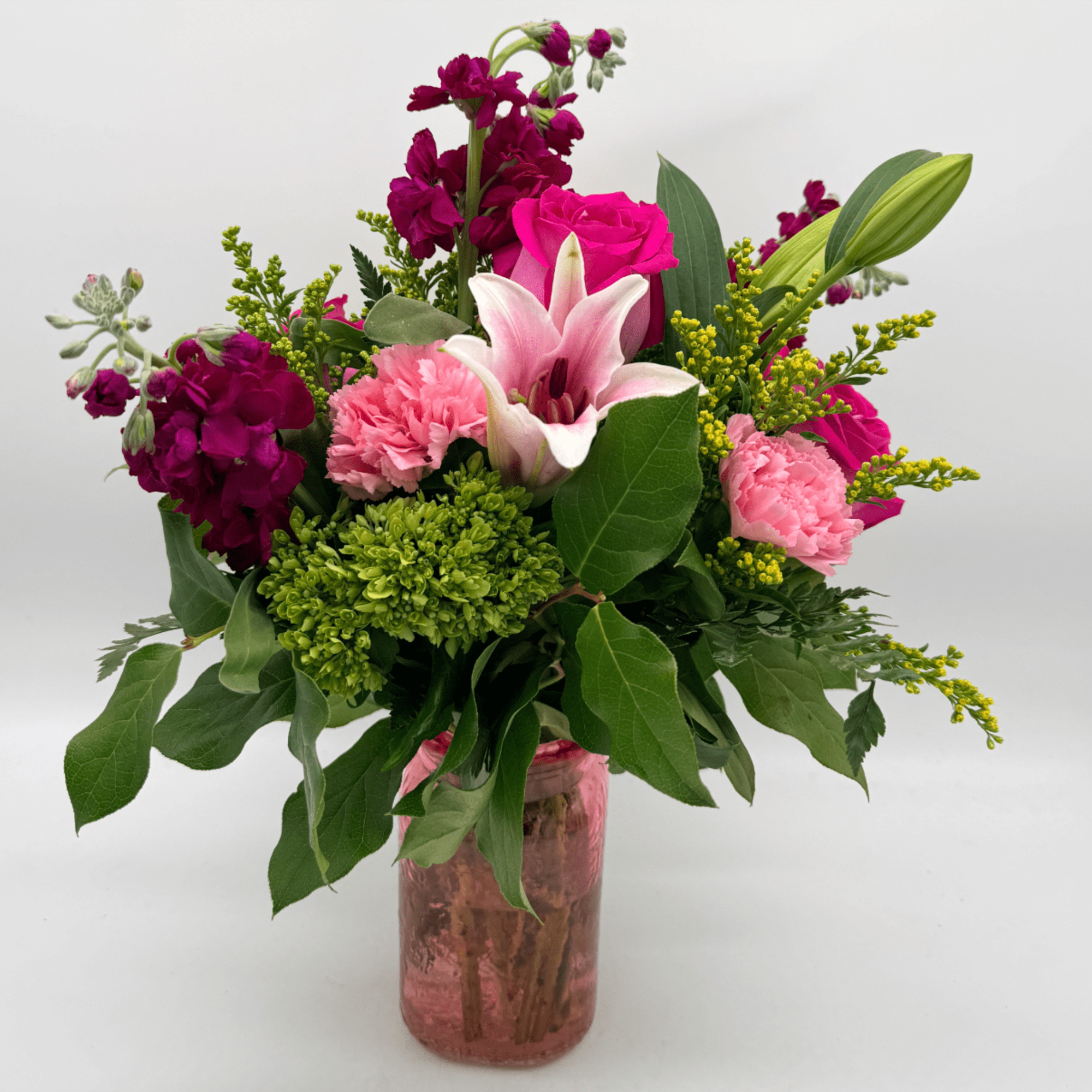 Fun, flirty, and full of color, this bouquet showcases roses, a lily
