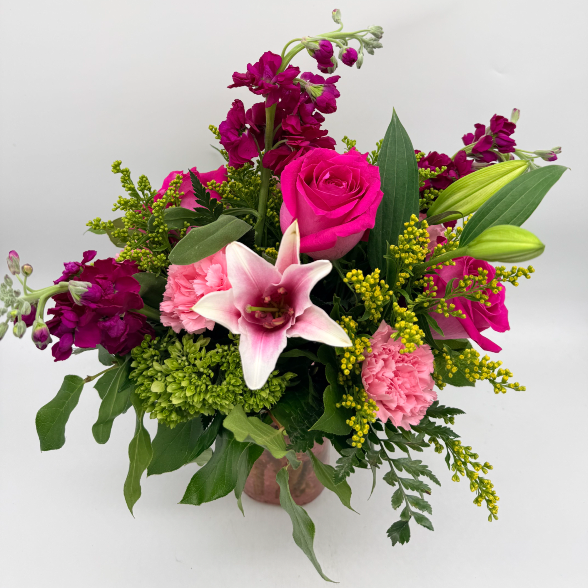 Fun, flirty, and full of color, this bouquet showcases roses, a lily