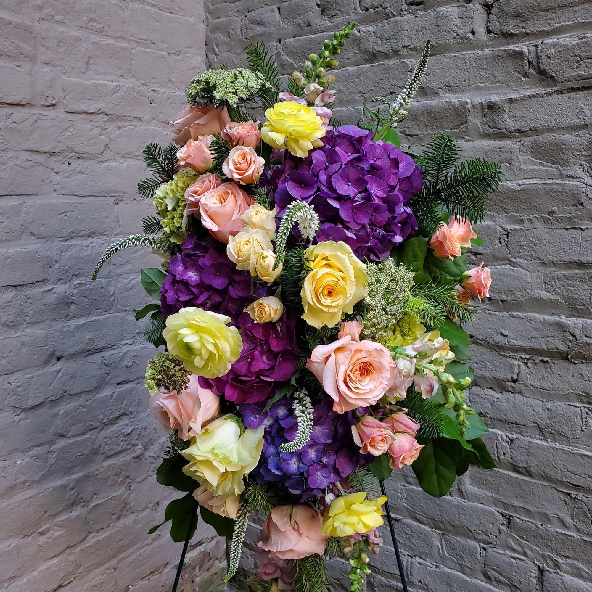 A standing display of flowers to celebrate the life of your loved