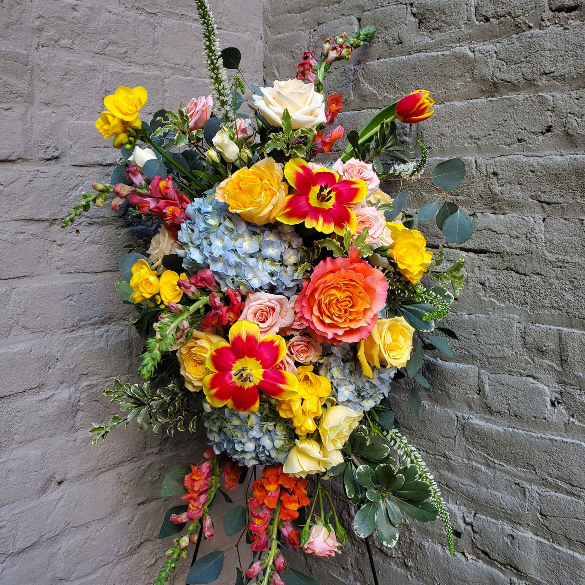 A standing display of flowers to celebrate the life of your loved