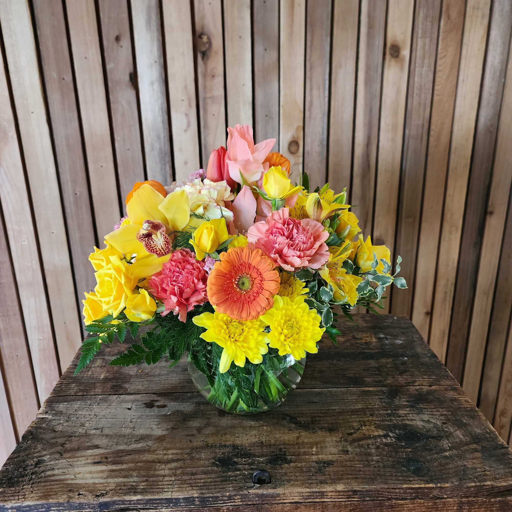 A bright seasonal bouquet of yellow, orange and pinks. 

*Marigolds are only