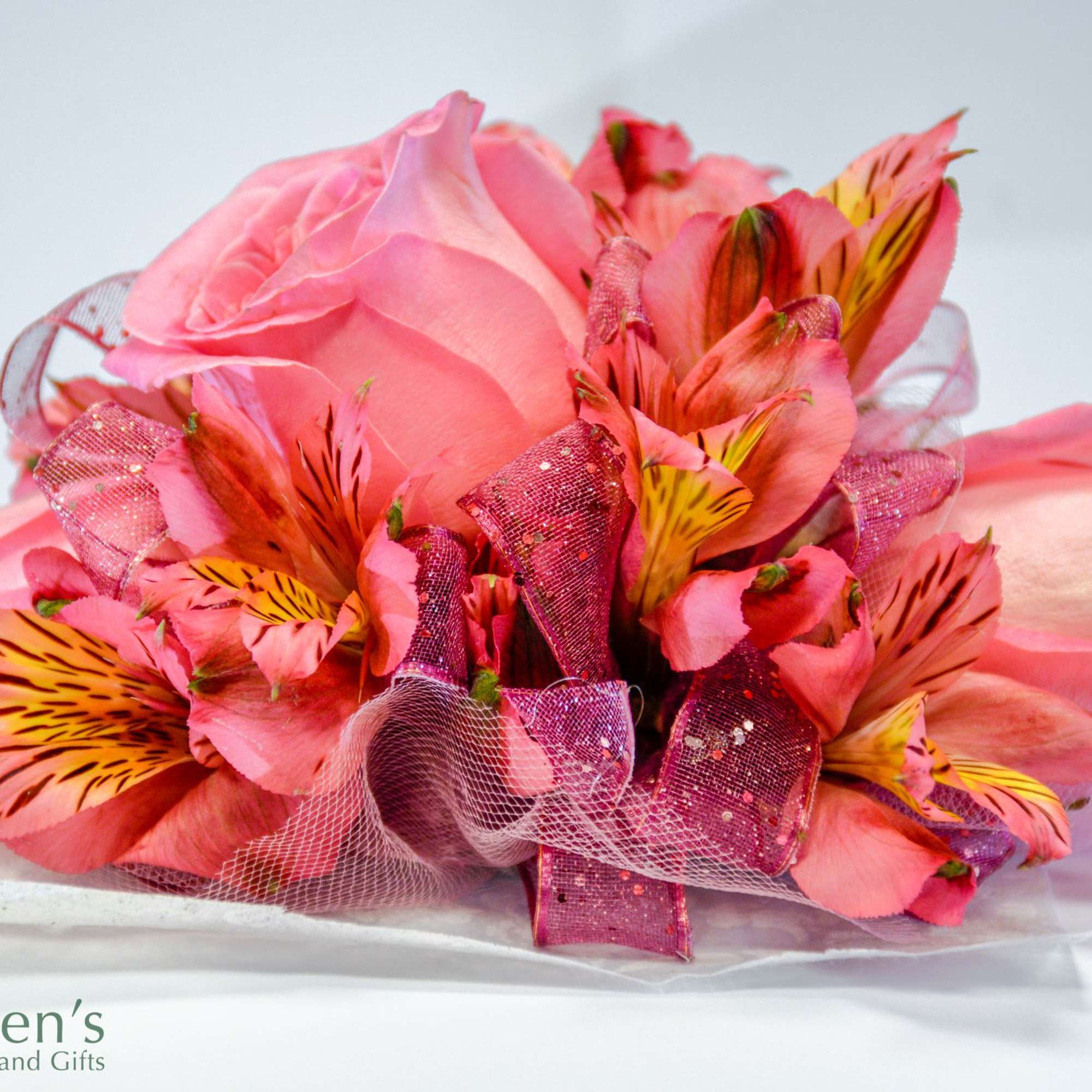 Pink rose bouquet with striped alstroemeria and glittery ribbon