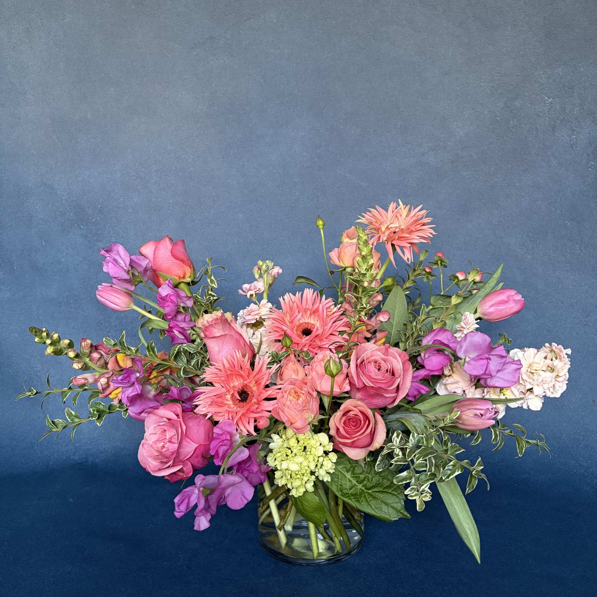 Pink and purple mixed bouquet in a clear glass vase