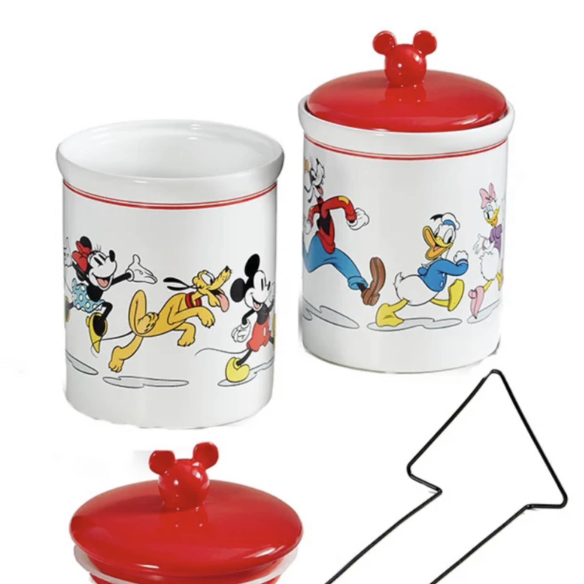 Two Disney character ceramic jars with red lids and a black serving utensil.