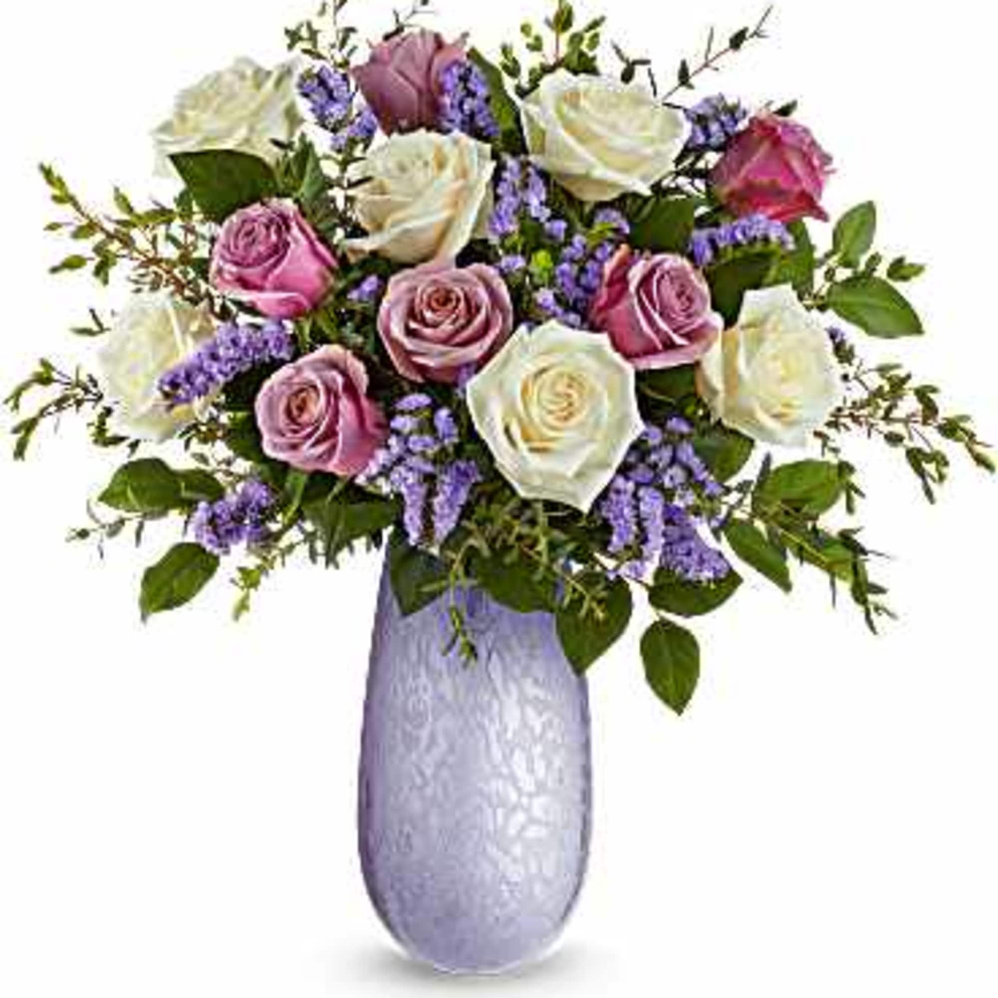 Bouquet of pink and white roses in a lavender vase