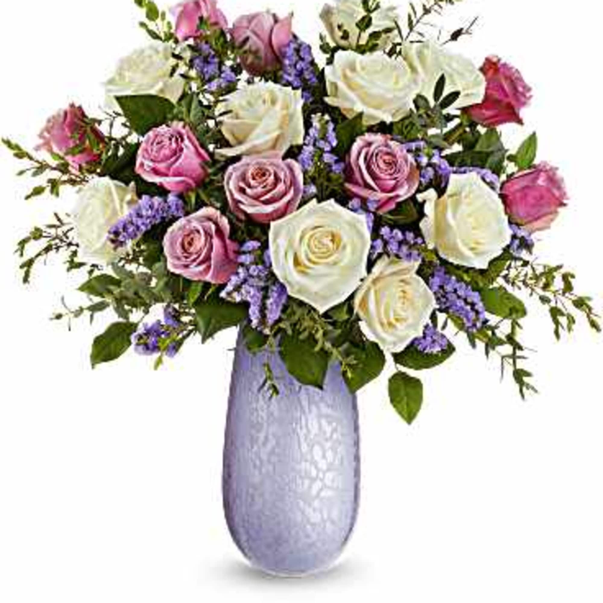 Bouquet of pink and white roses in a lavender vase