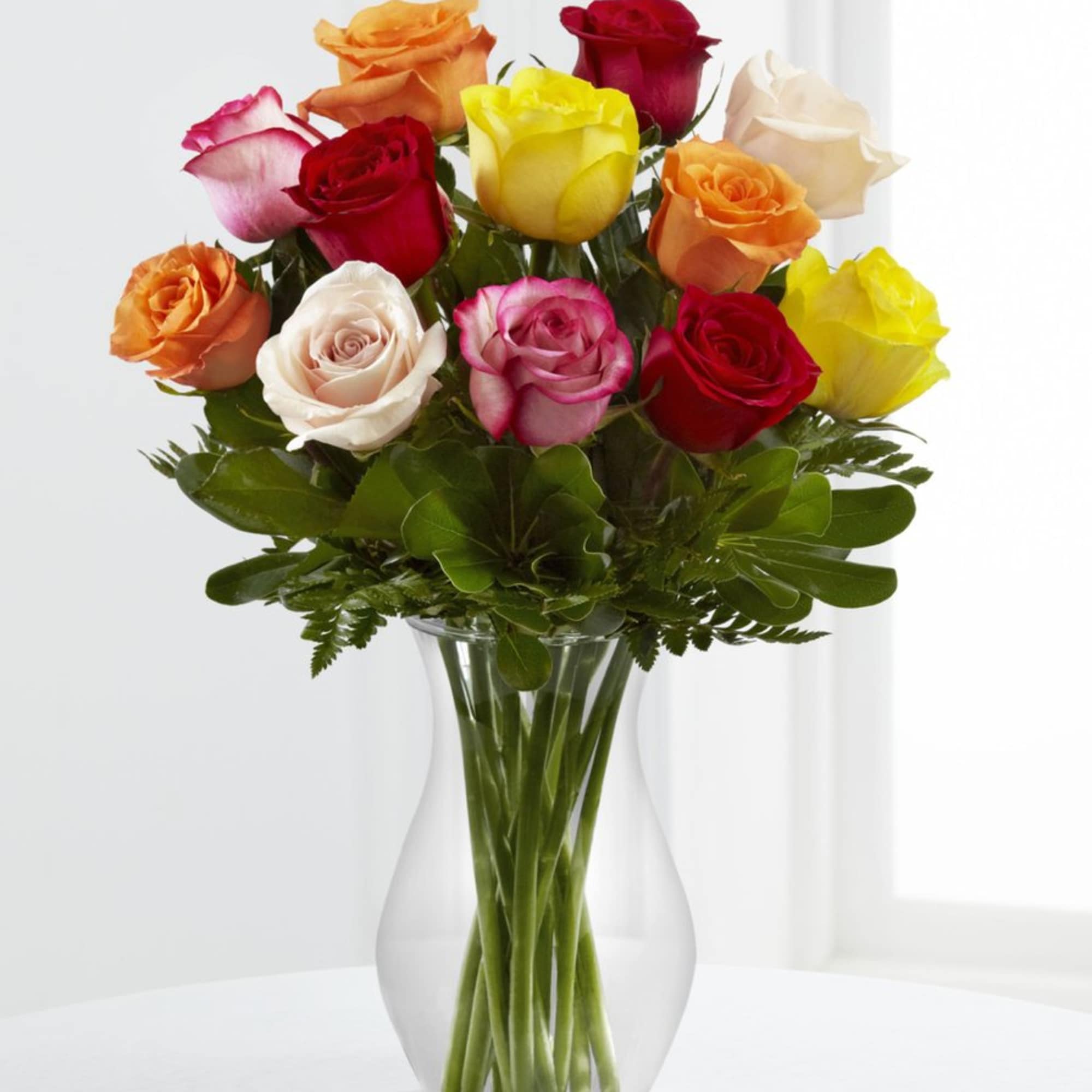 1 Dozen Mixed Roses.
Please note colors and container may vary.
