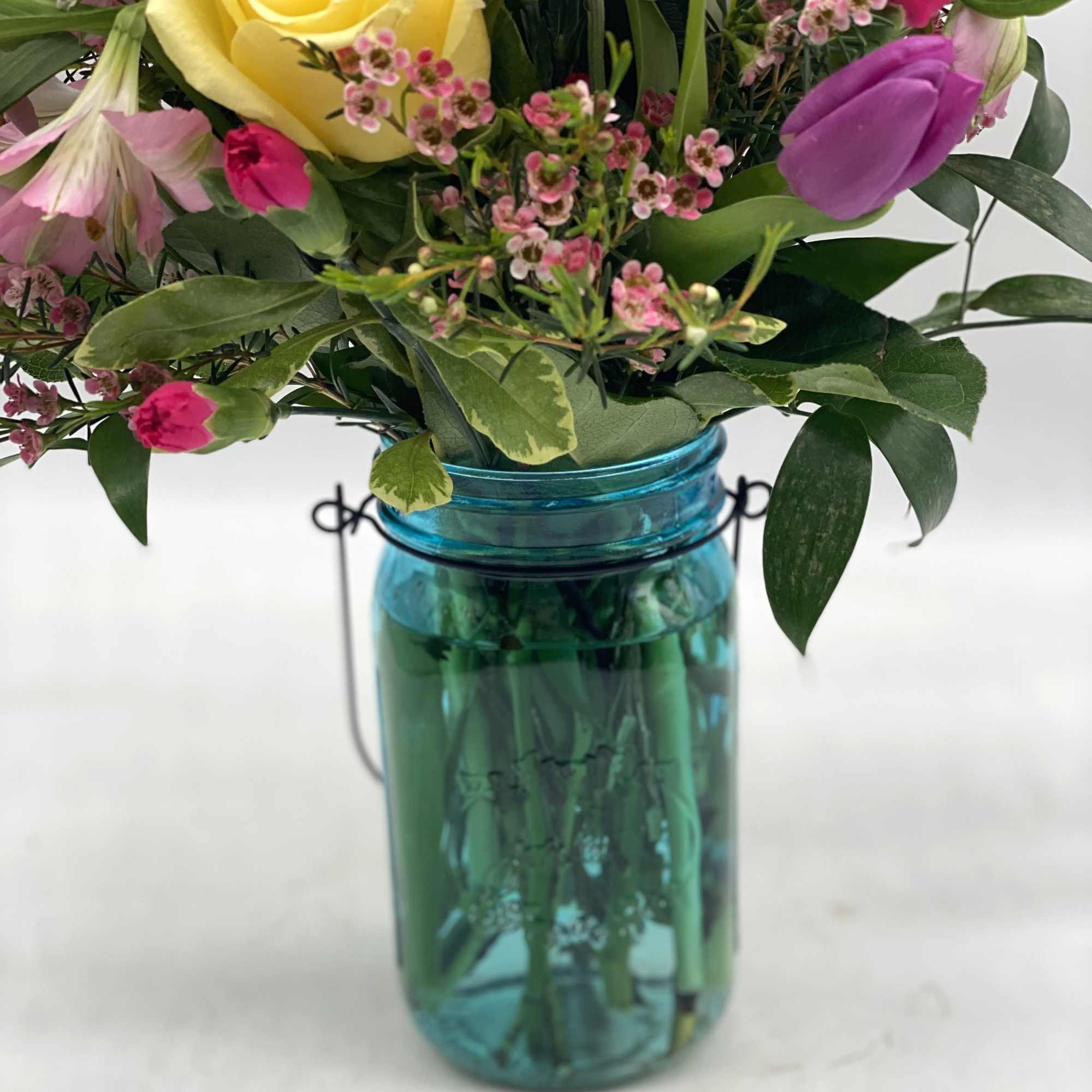 A nice mix of fresh blooms for mom designed in a hammered