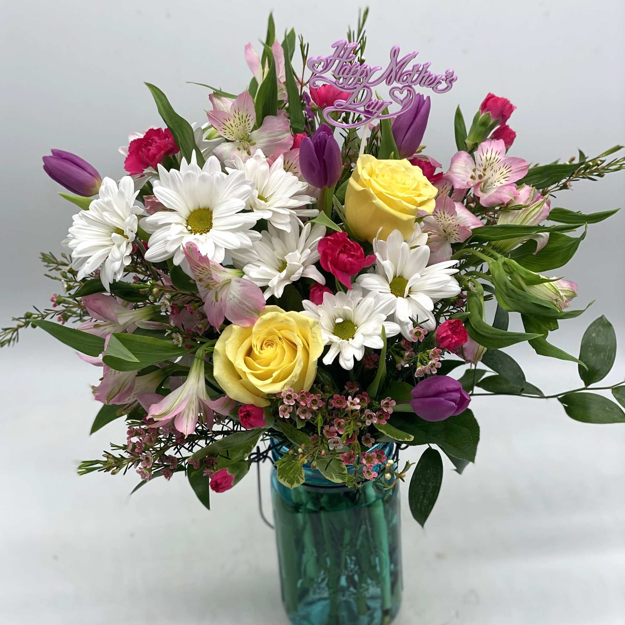 A nice mix of fresh blooms for mom designed in a hammered