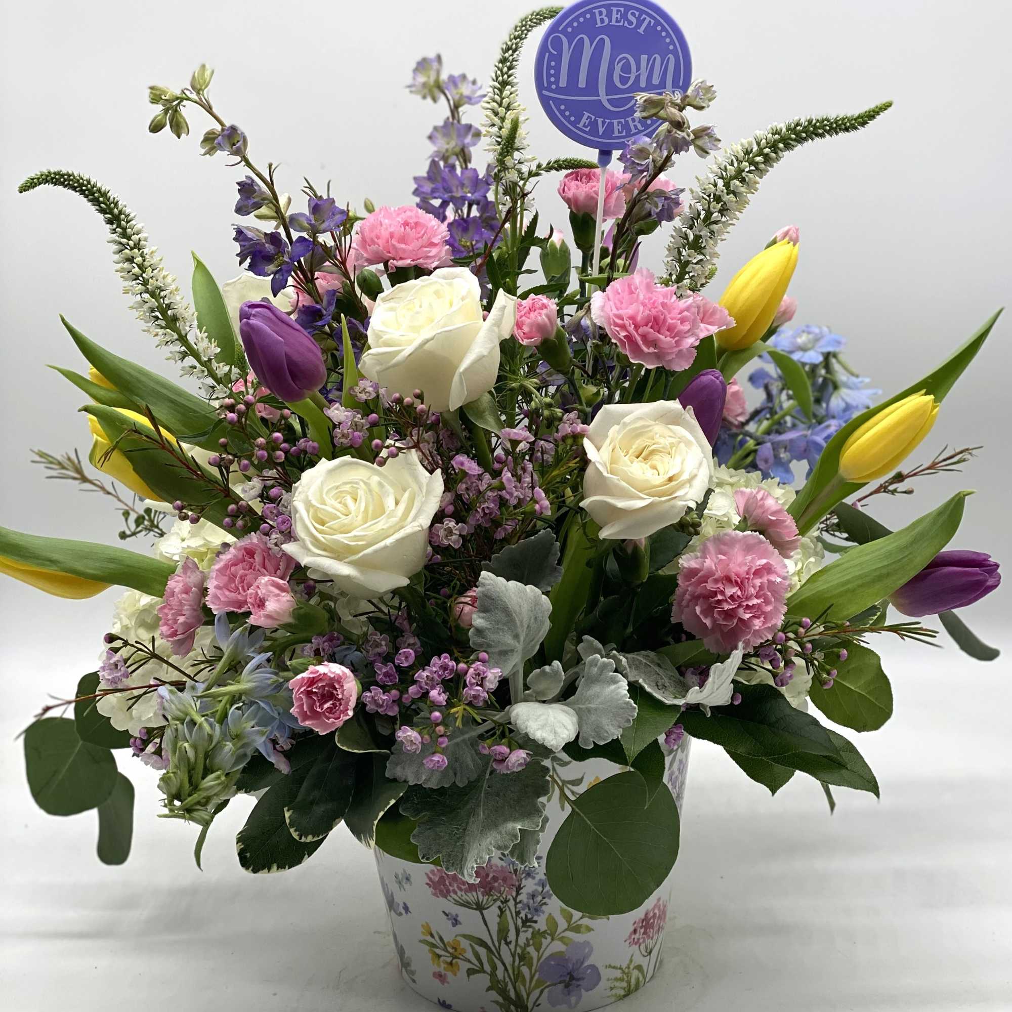 A beautiful mix of blooms designed in a container with a gorgeous