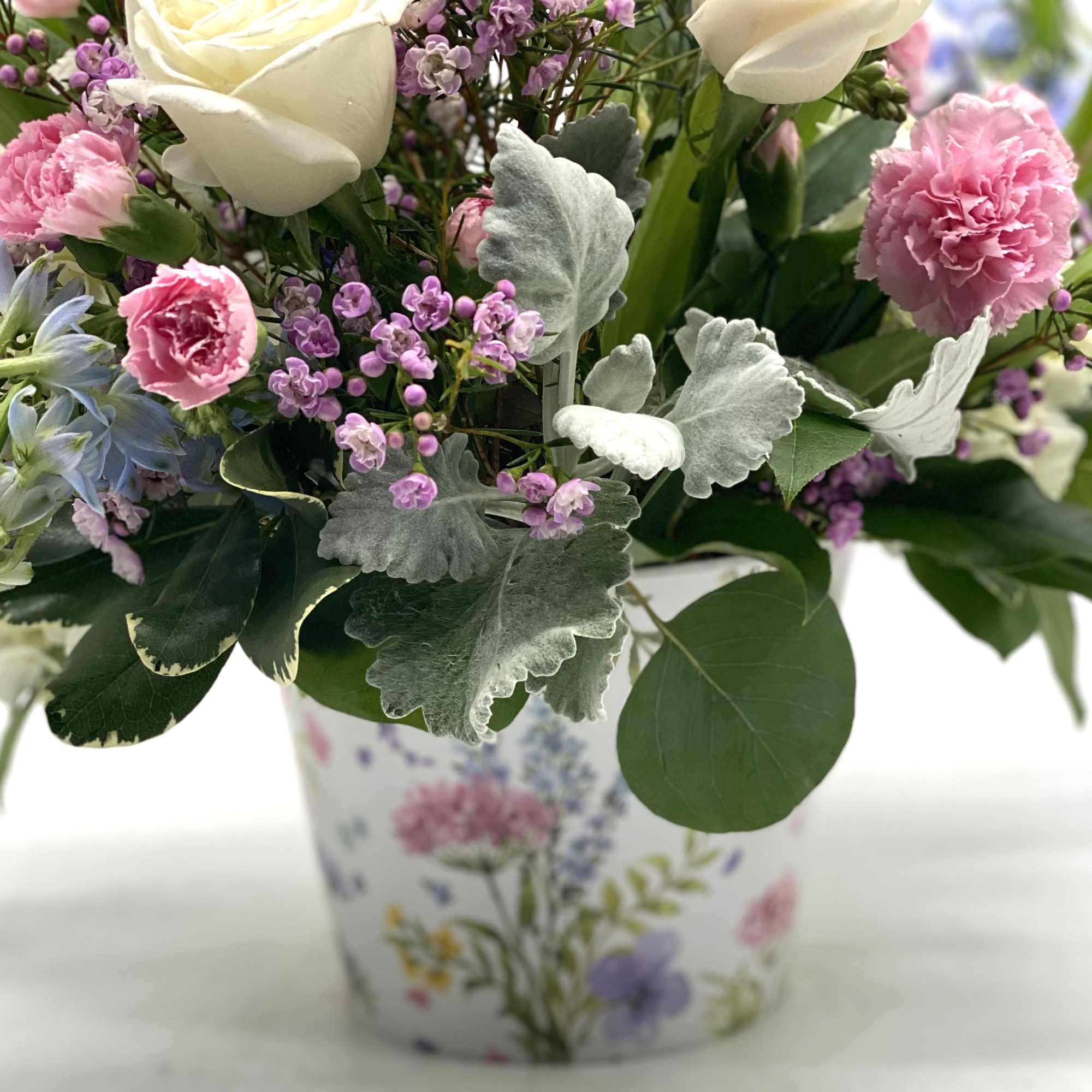 A beautiful mix of blooms designed in a container with a gorgeous